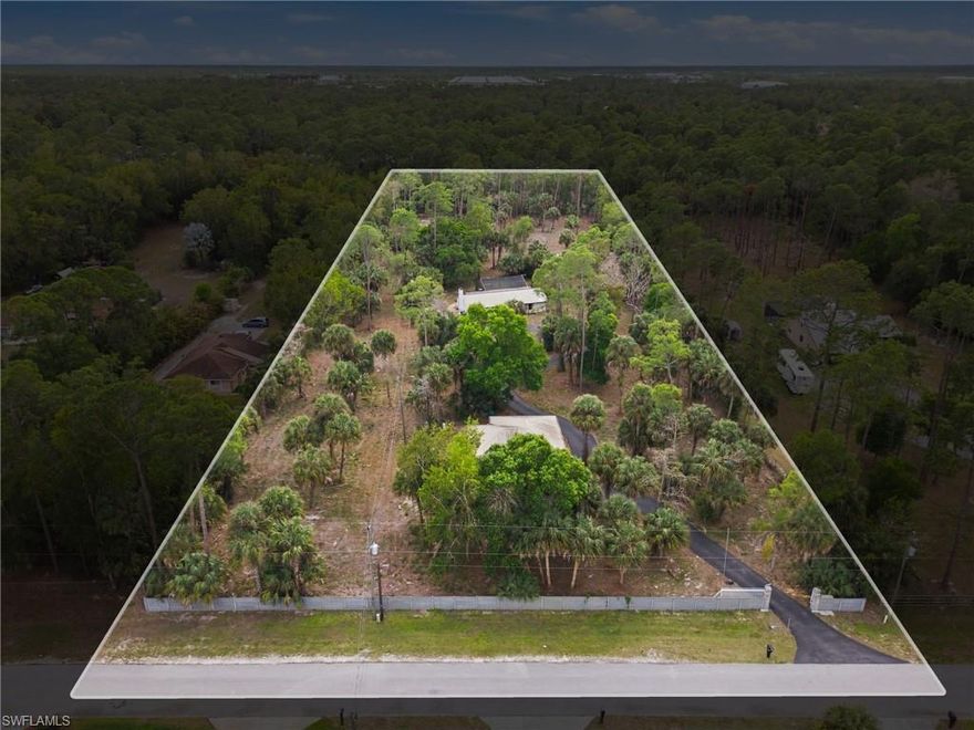 This 3.41 acre parcel in Naples with two dwellings is an exceptional buy for investors, builders, or buyers with vision. The main residence offers 3 bedrooms, 2 bathrooms and a pool. The cabin-style guest house built in 2018 features 2 bedrooms, 1.5 baths, laundry, whole-house generator, impact doors/windows and a metal roof. An ideal space for guest quarters, rental income, studio or home office. Property includes a gated, paved circle driveway and offers ample room to expand, redesign or build new! Larger lots in this area are increasingly scarce, making this a standout long-term value in a convenient location for Golden Gate Estates.