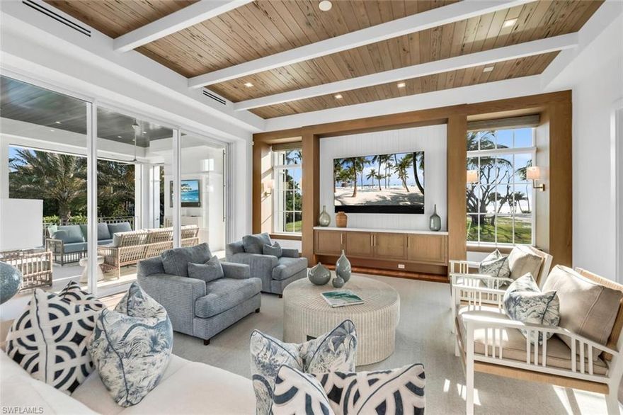 Experience exceptional coastal luxury in this Gulf-view estate built by Stock Custom Homes, designed by Stofft Cooney Architects, and furnished by Ficarra Designs. Located on a full-sized southern exposure lot with near-immediate beach access and just minutes from 3rd Street South’s dining and shopping, this home blends elegance and convenience. The main level features a luxurious primary suite and guest suite, along with a club room showcasing a full bar and Gulf views. An elevator provides seamless access to all levels, including the garage. The upper level offers four additional bedrooms, a secondary laundry, bonus living area with wet bar, and a spacious loggia capturing stunning sunset views. Additional highlights include remote-controlled hurricane shutters and screens, natural gas, whole-house generator, remote shades, maintenance-free backyard with gas fire pit, whole-house water filtration system, and two 8,000-lb vehicle lifts. A rare opportunity offering premier craftsmanship, timeless design, and an exceptional Naples coastal location.