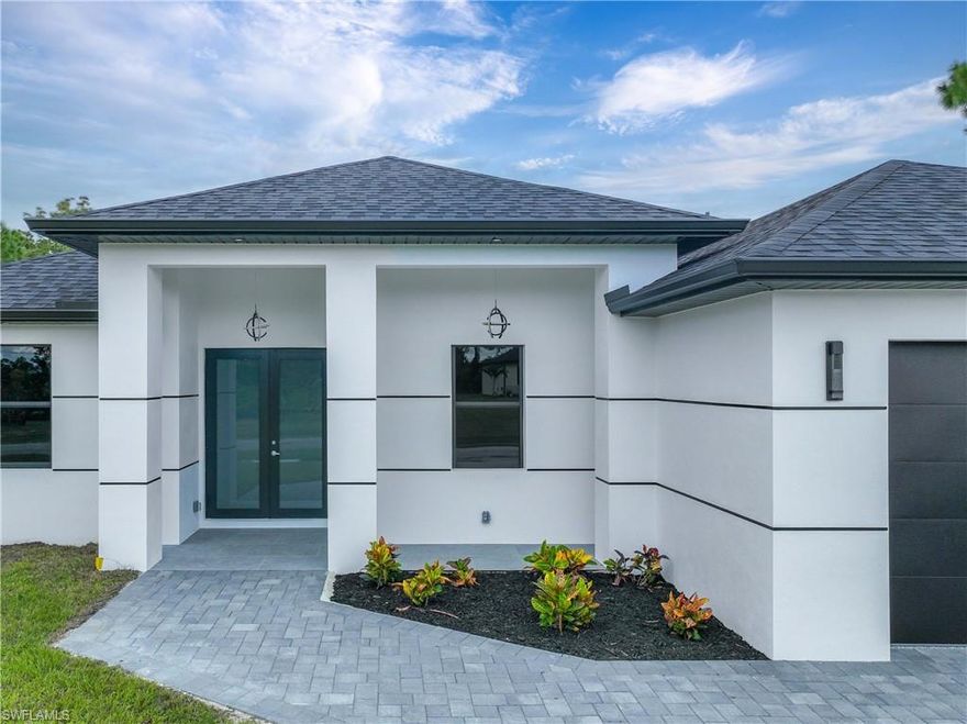 NEW CONSTRUCTION, luxurious contemporary home with plenty of room for parking. This home is impeccably designed and built with attention to every detail. All lights throughout the home are LED, all doors and windows are high impact and includes a sprinkler system. The open floor plan seamlessly blends indoor & outdoor living. Double entry doors welcome you into the light and bright interior with a wall fireplace, Sofi in the master bedroom ceiling. Impeccable white 36x36 porcelain title floors with membrane under tile, which prevents cracks from wear and tear. Expansive living room with high 10"tall ceilings. The kitchen boasts gorgeous 42" solid wood soft close cabinets with quartz countertops, a broad counter height island along with stainless steel appliances. The guest bedrooms are large with tall ceilings and ample closet storage. This 
Home is close to shops, restaurants, schools and THE BEST SW FLORIDA CAN OFFER.