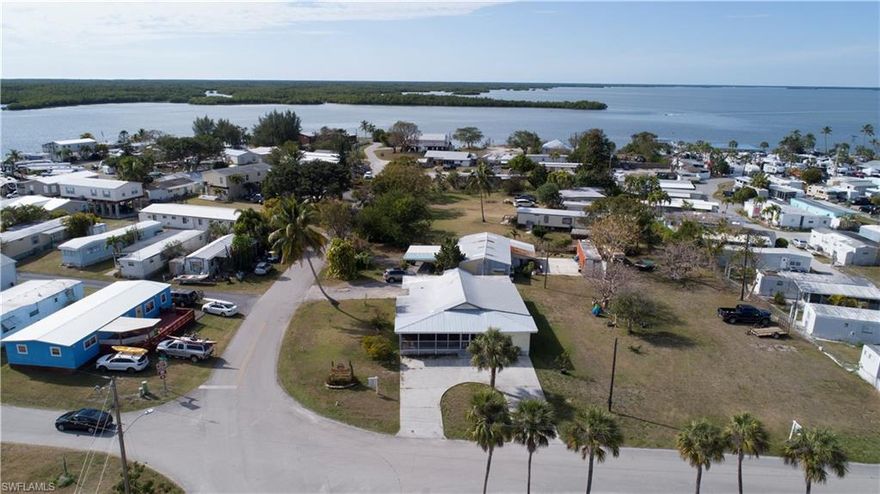 Fisherman's paradise in the heart of Chokoloskee.  This is true Olde Florida home built in the 1930.  Three bedroom each with their own bathroom.  This property has two lots. Detached garage and workshop, plenty room to park your boat, RV and other toys and still add your pool.