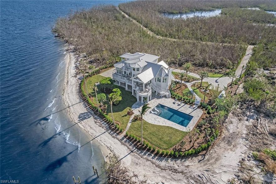 This simply is the best tropical beachfront shoreline along with deep water boating access on the entire island. One of the Primere properties in all of SWFL, This newly constructed Architecturally perfect home features a fabulous coastal timeless design and feel. An iconic location of historical significance on Sanibel Island. With over 1.5 acres and 200 feet of natural seashell shoreline facing to the west with unobstructed views across Pine Island Sound, this property is breathtaking. The property is surrounded on 3 sides by county and federal conservation land and the fourth side is San Carlos Bay offering unique privacy, iconic views and spectacular sunsets along with Deepwater direct access from your new dock including a 10,000 lb boat lift accommodating a 55-60 ft boat. 
The Home offers 3873 living sq ft w/over 10000 sq ft of total area to enjoy. 4 en-suites all with private balconies and water views… features include; Elevator, beautiful hard wood floors, impact windows and doors, wolf and subzero appliances. A large 20’ x 40’ waterfront pool. Fantastic Lani and deck space,  concrete construction , private gated entry and more. A generational type property that compares to no other!