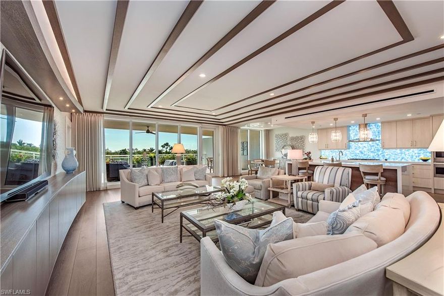 This terrace residence at Kalea Bay delivers a rare balance of scale, privacy, and architectural detail—living more like a private coastal home while remaining fully immersed in a refined resort setting. The expansive lanai, spanning over 1,100 square feet, is among the largest available and thoughtfully designed with both open-air and covered living spaces. Multiple seating areas, a built-in fireplace, and a lush planter garden create a layered outdoor environment that feels both intimate and elevated—ideal for entertaining or quiet retreat.
Inside, the three-bedroom plus den floorplan is carefully composed for both comfort and flow. Each of the two guest suites is a true ensuite, offering privacy and beautifully appointed baths. Wide-plank Legno Bastone hardwood flooring runs throughout, complemented by a custom-designed wood ceiling that adds warmth and architectural interest to the main living areas. A built-in bar further enhances the great room, creating a natural gathering space anchored by clean lines and thoughtful detail.
The kitchen and butler’s pantry are executed at a level consistent with a custom luxury residence. Wolf natural gas cooktop, Sub-Zero and Wolf appliances, and imported cabinetry are paired with a dramatic waterfall-edge island and 3" mitered edge quartz countertops. A backlit glass backsplash introduces a refined focal point, balancing function with visual impact. Every element has been selected for both beauty and function. 
The primary suite is designed as a private retreat, featuring custom built-ins, a dedicated vanity, and generously scaled  custom closets. The overall design emphasizes comfort and understated luxury.
What distinguishes this residence is the balance it offers. You have the benefit of an expansive, private lanai—one of the most livable outdoor spaces in Kalea Bay—while also enjoying access to the tower’s rooftop pool and lounge. Just an elevator ride away, panoramic Gulf views provide the “top of the world” perspective and nightly sunsets Naples is known for. It is a seamless blend of private outdoor living and elevated coastal vistas.
All of this is complemented by Kalea Bay’s amenity-rich lifestyle, including multiple resort pools, an adult-only pool, a state-of-the-art 14,000 sqft wellness center, tennis and pickleball facilities, two restaurants —delivering a true five-star living experience you can only experience at Kalea Bay