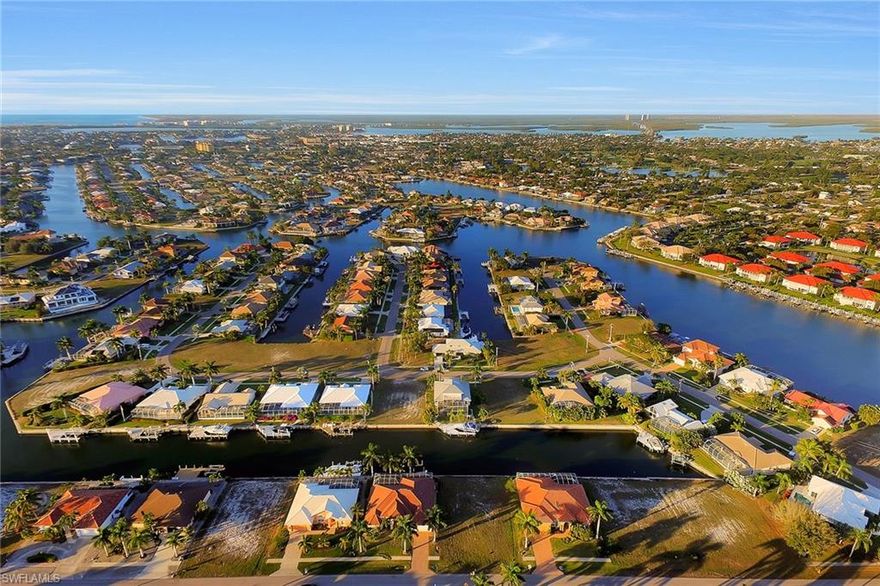 This lot is in a neighborhood of newer homes and is located only eight-tenths of a mile from Residents Beach and a short pleasant boat ride to the Esplanade with waterside dining and shopping. The recently finished Smokehouse Bay Bridge with heightened elevation offers you access to the Gulf of Mexico.