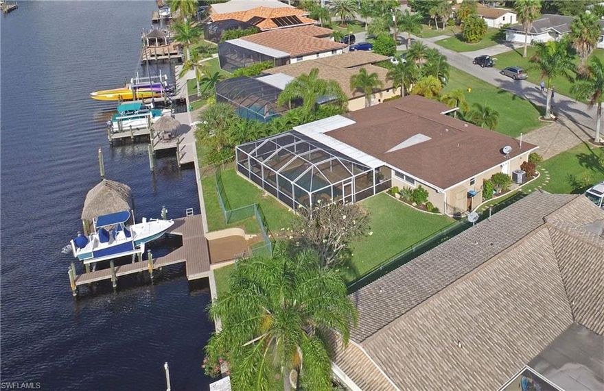 Location, location, Savona Neighborhood...Sailboat Access with intersecting wide water views, 1 block from river. Stunning water views greet you as you enter this custom remodeled home. Expansive great room boasts living/dining area plus large Florida room, beautiful kitchen with SS appliances, built in pantry and breakfast bar.  The expanded master bedroom features en suite bath with dual sinks and exotic granite, custom shower and large walk-in closet. Guest suite has built-in queen murphy bed, desk, shelves and storage.  Remodeled guest bath boasts exotic granite & linen closet. Custom upgrades abound including leaded glass entry door, 20" porcelain tile, new carpet, crown molding, 6" baseboards, canned lighting and built in surround speakers.  The AC unit (3.5 ton), roof, electrical panel & water heater have all been replaced.  The lanai boasts a beautiful heated saltwater pool with large spa and gorgeous summer kitchen. Relax on the deck with oversized tiki hut and 10,000 # boat lift.  This tropical paradise is a MUST SEE!!!