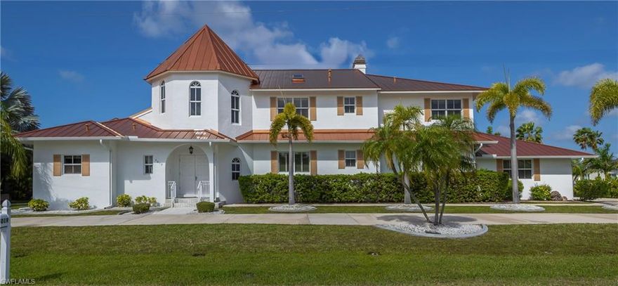 This stunning Mediterranean-style executive estate sits on two premium waterfront lots offering 160 feet of sailboat-access canal frontage. Enter through an impressive tower entrance that sets the tone for everything that follows. A beautifully crafted solid oak staircase greets you upon arrival. The heart of the home is a soaring great room with its dramatic ceiling height, walls of windows flooding the space with natural light, and rich oak paneling adding warmth and sophistication. The main sitting area anchors around a classic fireplace — ideal for Florida's cooler evenings — while the open layout accommodates multiple conversation areas perfect for entertaining on any scale. Gleaming 23-inch tile flows throughout the living areas on the main floor, and a wraparound second-floor balcony overlooks the entire space from above. The well-appointed kitchen features 42-inch cabinetry, Corian countertops, stainless steel double refrigerator/freezer, a center island with cook top, built-in desk, and casual dining area. Every inch has been designed for the home chef who loves to entertain. The adjacent formal dining room is bathed in natural light, framed by handsome wood beam ceilings, and overlooks the pool and waterfront. Built-in corner cabinetry throughout provides generous storage without sacrificing style. The expansive master suite is a private sanctuary. A newly installed private elevator connects the master level directly to the upstairs den, adding a sophisticated convenience rarely found in residential properties. The recently updated master bath showcases white wood cabinetry, dual sinks, a deep soaking tub, and a generous walk-in shower. A large walk-in closet and a separate walk-in linen closet ensure that storage is never a concern. An adjoining air-conditioned flex room — ideal as a home gym, workshop, or creative studio — includes a half bath. A second bedroom on the main floor near the entry features a custom built-in bed and walk-in closet, served by a beautifully updated bath with wood cabinetry, marble countertops, and a walk-in shower. Upstairs, a third bedroom offers access to a large cedar-lined closet as well as a full bath featuring a tub, tile floors, and quartz countertops. At the end of the upper hallway, a handsome oak-paneled den with fireplace provides a quiet retreat. Rounding out the upper level is a delightful English-style pub complete with built-in bar seating and custom woodwork — great for entertaining and a truly unique feature that sets this property apart from anything else in the area. The screened lanai features a sparkling pool and spa alongside a gallery-style covered passage along the exterior of the great room — an elegant transition between indoors and the waterfront. Whether you're a day sailor, offshore angler, or simply love waking up to waterfront views, this property delivers the quintessential Florida boating lifestyle. See this property today! You won't be disappointed!