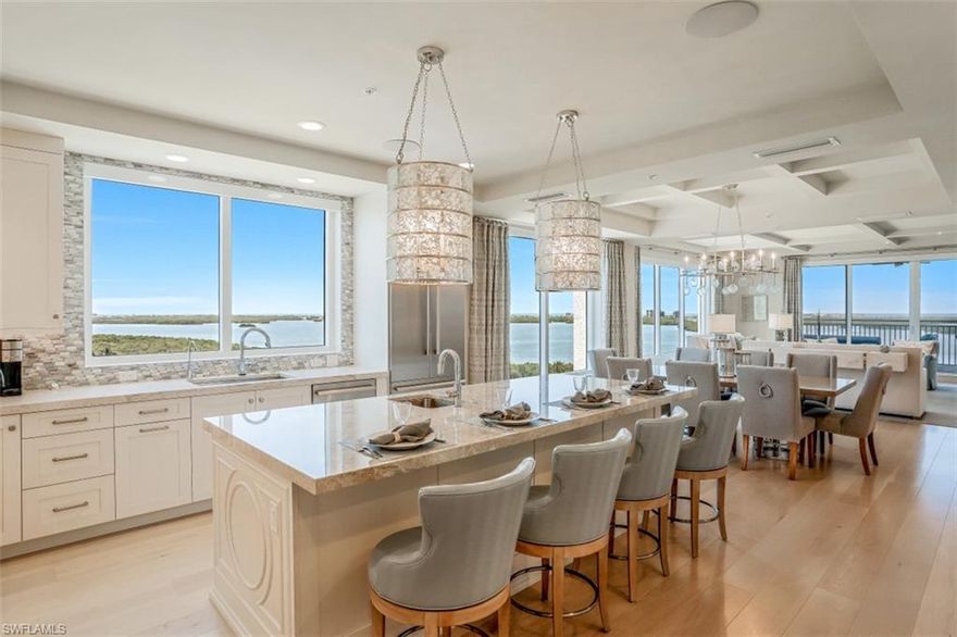 Modern open floor plan, END UNIT w/floor to ceiling windows & unmatched views on 3 sides with coveted, private, enclosed 2 car garage valued at 150k+! Be impressed by the LUXURIOUS finishes & great attention to even the smallest of details. Over 3400 sq ft under air, boasting 3BR PLUS a den, located in Bonita Bay's newest high rise, Seaglass. Sophisticated & stately, this home is conveyed w/countless custom upgrades including American oak floors throughout, 2" thick quartzite countertops, custom cabinetry, expanded pantry/dry bar, gorgeous lighting fixtures, window treatments, custom closets & so much more! The '01 floor plan offers ample space for entertaining guests. The master BR is impressive & allows access to the lanai. The master bath boasts upgraded counter-tops & oversized shower. Both guest BRs offer en-suite baths & balconies. Complete w/large den/office, this unit is so spacious, it lives like a single family home. You will love the Western facing lanai w/SO MUCH ROOM for enjoying FABULOUS sunset views, outdoor cooking/dining & relaxing w/your favorite cocktail. Fabulous amenities-resort pool, fitness center, theatre room, rooftop terrace & more. SEE ACCOMPANYING VIDEO!