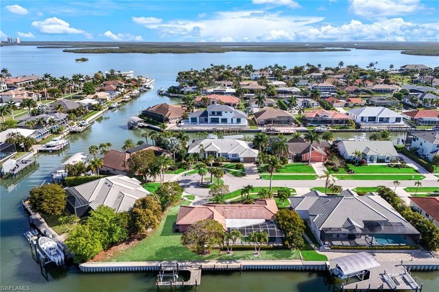 New seawall 2024. Direct-access southern-exposure home on a key lot with 160 feet on the water. Great lot to build your Dream Home.