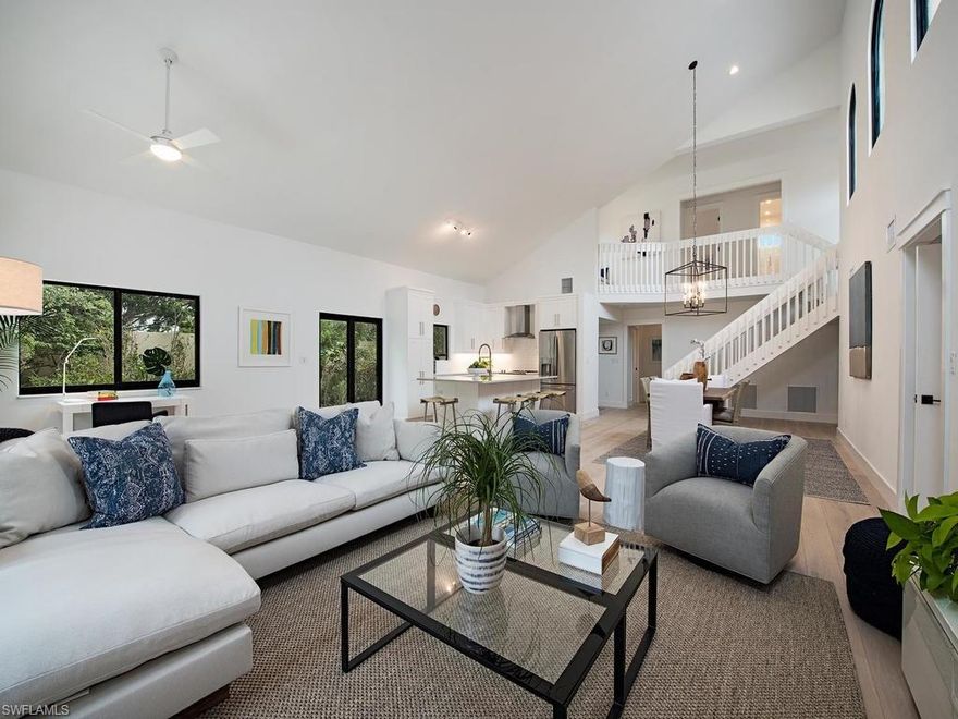 Bright, oh so current, classic coastal transitional remodeled villa in the heart of Pelican Bay. Private end unit with enormous courtyard space and refinished pool and deck, this villa was taken down to the slab, walls removed, and the dated floorplan completely reimagined and opened up, allowing light from all four sides of this soaring ceiling home. New impact glass sliding doors and windows, stunning French white oak wide-plank wood flooring throughout, new base molding, door casing and Emtek hardware, with open-format architectural stairs covered in cozy wool sisal. Owners' suite boasts new paneled ceiling detail, expanded master bath with dual sinks, shower and modern, freestanding tub, and groovy custom barn door entry to enlarged master closet. Brand new custom kitchen features all new layout, with fabulous Calcutta quartzite island, crisp white shaker cabinetry, new stainless steel appliances and plumbing fixtures. Two additional bedrooms share the large guest bath with shelistone floors, crisp wavy white subway tile walls, and new plumbing fixtures, cabinetry, lighting and hardware. The entire home is freshly painted, fully furnished and ready for its first residents!