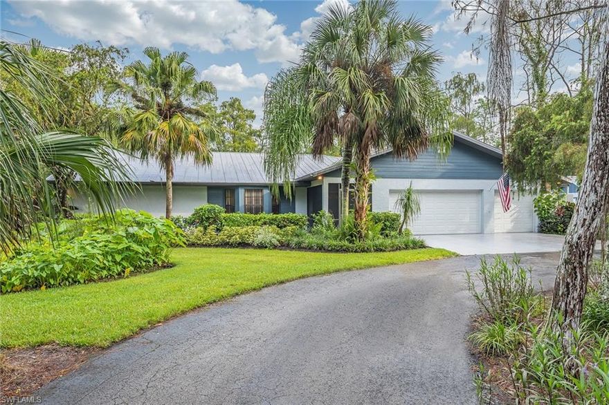 Town and Country meet on this beautiful 2.57-acre, ranch style home in the North Naples community of Logan Woods. This traditional footprint offers an abundance of room. The wrought iron fencing on the side and front of the property with an automatic gate welcomes you on to the circular drive outlined with thoughtful landscaping lending itself to an abundance of privacy. Entertain your family and guests in the formal living and dining room or the large family room adorned with a beautiful brick fireplace. Enter the oversized lanai from the French doors in the family room, dining room or master suite. This home offers a large 3 car garage with additional storage space, total home reverse osmosis system, two air conditioning systems, metal roof, screened front porch, large tile on the diagonal in the family room, kitchen, foyer, laundry and one guest bedroom. There is a 10 x 10 outbuilding with electricity perfect for a workshop or storage. Enjoy estate living, yet close to beaches, shopping, restaurants and top-rated schools.