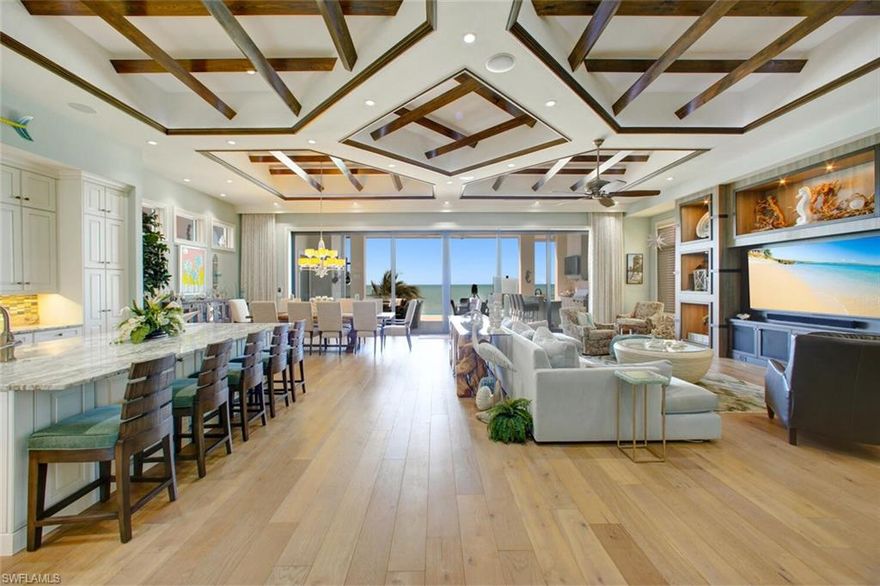 STATE-OF-THE-ART, DIRECT BEACHFRONT, RECENTLY CONSTRUCTED HOME ON BONITA BEACH! Boasts only the finest high-end coastal contemporary finishes with panoramic Gulf of Mexico views as the backdrop. Incredible open floor plan highlights the beachfront setting, with fully pocketing sliders that open to the elevated entertainment deck with dramatic infinity edge pool & spa, summer kitchen with gas grill & fireplace, all overlooking the Gulf with glass railings to optimize the views. This 5 bed + den  home boasts a bonus recreation room with workout space, double laundries & an incredible top-floor bonus entertainment room with second wet bar. No details overlooked with wood floors, volume ceilings with stunning wood beam details, designer lighting features & all quartz/granite counters. Chef’s kitchen includes separate bar with seating & stunning climate-controlled wine room with glass display walls. Also includes impact doors/windows, elevator & smart automation system for climate, lighting & music. Ideally located minutes to Mercato & North Naples’ amenities with easy access to I75 & the International Airport. Enjoy the best of the best; all overlooking the stunning Gulf of Mexico.