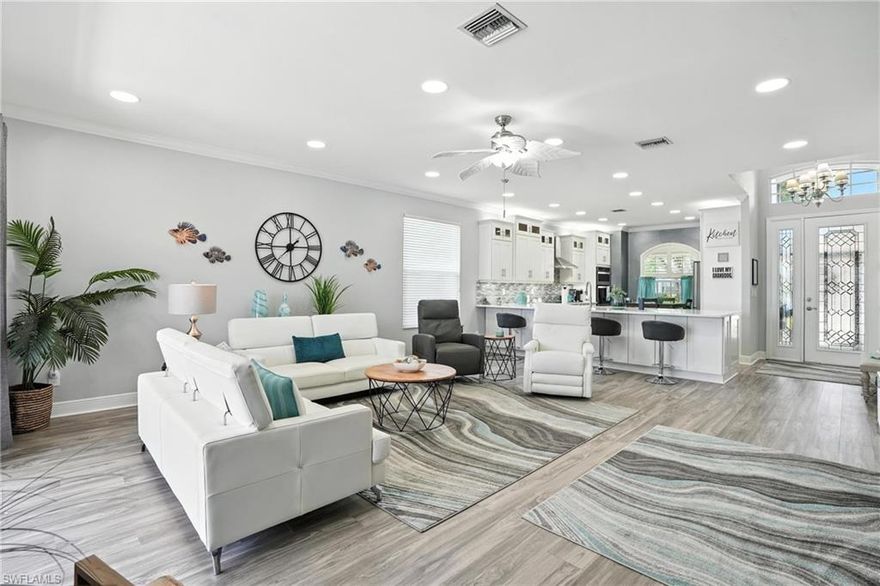 Sophistication Meets Serenity Meets Value in This Stunning SilverLakes Residence **All Big Ticket Items Taken Care Of For You.** Welcome to refined Florida living in the prestigious, gated community of SilverLakes in The Gateway. This meticulously maintained home blends timeless elegance with modern updates, offering three spacious bedrooms and 2 luxurious baths in one of the community’s most sought-after floorplans. From the moment you step through the vaulted entryway, you’ll be captivated by the home’s flowing open-concept design. The expansive great room, kitchen, and dining area provide the perfect setting for both relaxed everyday living and elegant entertaining. The completely remodeled gourmet kitchen impresses with crisp white cabinetry, stainless steel appliances, a massive island with bar seating, breakfast nook, and ample pantry—blending function and style with ease. Throughout the home, sleek plank flooring adds an air of luxury, while the trim and finishes sparkle. The primary suite is a private retreat, featuring well-lit roominess, dual vanities, a spa-like step-in shower, and wonderful walk in closet. Natural light floods every room, accentuating the graceful finishes and thoughtful details such as crown molding, designer trim, upgraded counters and appliances, and the luxurious view over your pool and the lake. Step outside to your own piece of Florida—overlooking the tranquil lake and take a dip on your own pool covered by a screened lanai offers- the perfect place to relax or entertain in privacy. This exceptional residence is built with both beauty and resilience in mind.