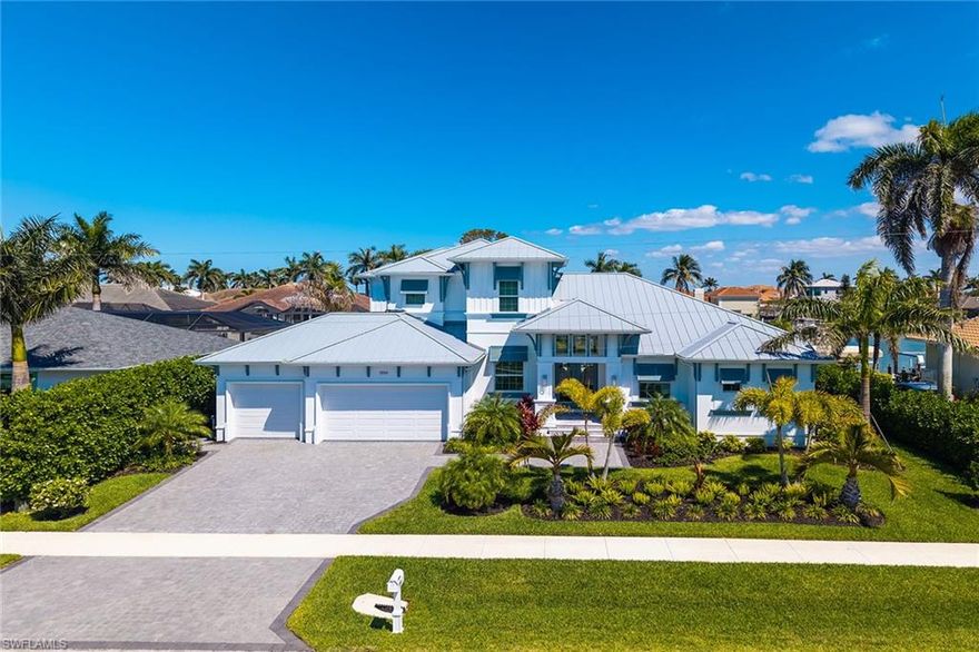Experience captivating coastal living in this luxurious waterfront home. Quick direct access to the Marco River, Gulf of Mexico and backwaters. Endless boating and kayaking opportunities. Five bedrooms, four baths plus den. Crafted with the finest details. Open layout, soaring ceilings and abundance of light create living spaces that feel like an extension of the outdoors. Offered beautifully furnished in a sophisticated light and airy natural decor that captures the essence of relaxed coastal living. Chef's kitchen affords JennAir appliances including wine cooler,  stunning oversized center island in Pompei Perla quartz  seats 8-10 guests, Butler's pantry/coffee bar compliments the exceptional kitchen design.  Serene owner's suite affords  water and pool views , spa-like bath to unwind and recharge in luxury. Four privately located guest bedrooms plus three additional baths for visiting family and friends. A casual  family room for guests to gather and enjoy games or movies is situated away from the primary living areas. Expansive lanai with leathered travertine deck seamlessly transitions from the interior living spaces for outside living and entertaining. Sparkling saltwater pool for afternoon or evening swims with adjoining spa for leisure and hydrotherapy.  A 20,000-pound boat lift, 7,500-pound jet ski lift and additional sunning/dock area complement outside features of this impressive home. New seawall 2018 Home is roughed in for elevator should you wish to add one. Three-car garage. Lush tropical landscaping and lovely water views. An exceptional home offering a sophisticated and modern take on coastal living in the prestigious Marco River area on Marco Island.
