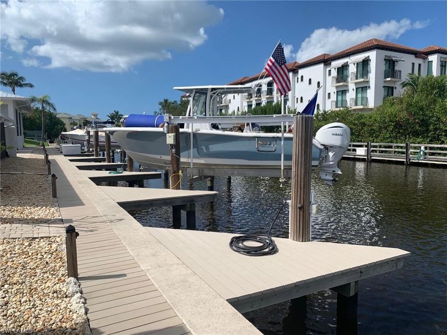 .This charming, Renovated, first-floor, 2-bedroom, 2-bath end-unit condo comes with an assigned boat dock for up to a 25 feet boat, seawall was replaced in 2020. Good for 50 years. Perfect for those seeking a serene escape. The contemporary kitchen features new white cabinetry, sleek quartz countertops, modern cabinet pulls, custom lighting. Updates throughout include Impact Windows, New A/C system, New Roof and modern finishes in the updated master bath. Enjoy endless aquatic adventures with direct access for boating and fishing enthusiasts, right at your doorstep, adding a new dimension to your Naples, FL lifestyle. Located close to pristine beaches, renowned downtown restaurants, shopping and adventures available at the nearby Naples Bay Resort and Marina.