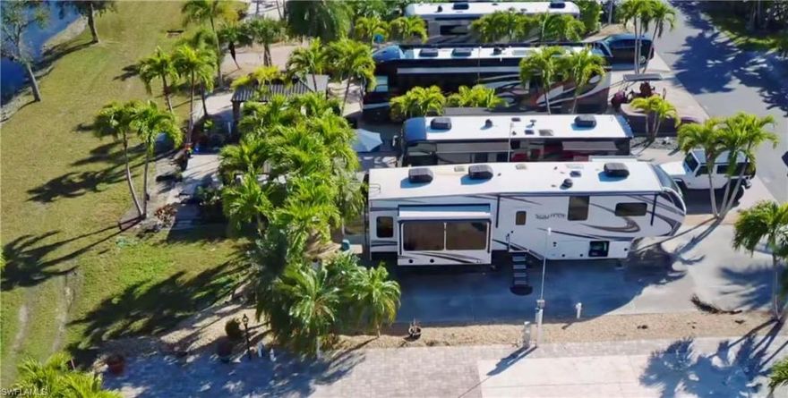Discover Your Slice of Paradise at Gulf Waters RV Resort

This exceptional 30’ x 100’ RV lot offers an unparalleled opportunity for those seeking a luxurious outdoor lifestyle, just minutes away from the stunning shores of Fort Myers Beach, Sanibel, and Captiva Islands. This prime lot is not only ready for your RV but also boasts a host of amenities designed for relaxation and recreation.

Recently enhanced with a quaint garden bridge and lush landscaping, this RV lot is a true gem. It is golf cart and pet-friendly, making it the perfect spot for families and animal lovers alike. 
Gulf Waters RV Resort is a premier destination, offering a wealth of amenities including a spacious clubhouse, a heated pool and spa, and a lively poolside tiki bar that operates during the season. 
Enjoy a game of pickleball on one of the eight courts available, or take advantage of the on-site laundry facilities, complimentary Wi-Fi, and varied electrical service options (20/30/50 amp) along with cable access.

Imagine spending your mornings watching breathtaking sunrises over the lake, taking refreshing dips in the heated pool, or sipping cocktails at the tiki bar while enjoying live music. Gulf Waters RV Resort is designed for both social engagement and peaceful retreats. Participate in a wide array of scheduled activities or simply unwind with new friends in this welcoming community.

Conveniently located just 4 miles from the beautiful Fort Myers Beach, the resort provides easy access to local attractions. You can stroll to the nearby trolley station, hop on a trolley, or explore the area on your bicycle. The resort is also in proximity to a variety of restaurants, shops, and entertainment options, ensuring that you have everything you need at your fingertips during your stay in this tropical paradise.

The community itself is fully gated, enhancing your security and peace of mind. You’ll find recycling bins and dumpsters conveniently located near the clubhouse, making it easy to maintain a clean and eco-friendly environment. The RV lot includes a sturdy cement slab, complete with electric and water hookups, making it ready for your immediate enjoyment.

Don’t miss out on this incredible opportunity to own a gorgeous RV lot at Gulf Waters RV Resort. Experience luxury RV living in a peaceful and picturesque setting, with the beach just a short drive away. Whether you are looking for a seasonal getaway or a permanent residence, this property has it all. Embrace the lifestyle you’ve always dreamed of—schedule your visit today and take the first step towards making this beautiful RV lot your own!