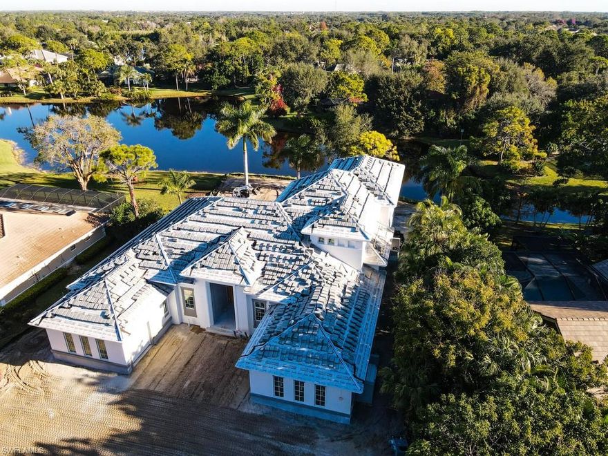 H.16154- UNDER CONSTRUCTION.  Completion March/April 2021. This coastal estate home offers 6,900 sq.ft. of combined indoor/outdoor living space located in Woodlake close to all the club activities. The flow-through floor plan was designed to take advantage of the long water view and natural lush tropical landscape. The first level has 3 en-suite bedrooms and a study. The owner’s bedroom and bathroom are in a separate wing of the house, providing exclusivity and privacy. The gourmet kitchen enjoys a breakfast nook, dining area, wet bar and large walk-in pantry. The second level has a 4th en-suite bedroom and spacious bonus room, morning kitchen and private outdoor terrace. The great room has an attractive back-lit tray, 14' ceilings, a focal wall and is complimented by wide plank European oak hardwood flooring. All the main rooms lead out to an expansive outdoor living area featuring a gas fireplace, kitchen, dining, seating area and bar overlooking the salt-water pool, with a sun shelf and spa, and the magnificent view. High quality interior finishes with attention to detail, spacious loft storage area, 3-car garage with motorcourt and circular drive. Built by Lombardi Development.