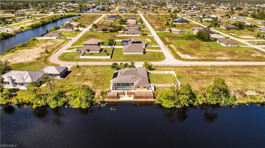 "ONE-OF-KIND" STUNNING WATERFRONT, 4 LOTS, BOATING, FISHING, SALT-LIFE, OVER $300,000 IN BUILDER/OWNER CUMULATIVE UPGRADES, TURNKEY FURNISHED, 4BDR, DEN, 3BTH, 2 CAR GARAGE, POOL HOME. SUPER CURB APPEAL WITH STAMPED CONCRETE DRIVE WAY & MATCHING PAVEMENT AROUND ENTIRE HOME. "X" ZONE, NO FLOOD INSURANCE. TILE THROUGHOUT WHOLE HOME WITH WOOD FLOORS IN MASTER , GUEST & DEN. HOME HAS 2 MASTER BEDROOMS. 16' VOLUME CEILINGS, LOTS OF GLASS WINDOWS & SLIDERS HOME LIGHT, BRIGHT. BIG KITCHEN, WOOD CABINETS, EAT-AT-BAR, STAINLESS STEEL APPLIANCES & PANTRY. MASTER BEDROOM HAS DUAL SINKS, SOAKING TUB & FLOOR TO CEILING GLASS & TILE WALK IN SHOWER. SOLAR HEATED POOL W/STAMPED STONE CONCRETE DECK. HUGE 80' TREX OBSERVATION DECK OVER THE WATER FOR FAMILY GATHERINGS OR FISH FROM YOUR BACK YARD. STAIRWAY DOWN TO 2ND PATIO DECK & BOAT DOCK. HOME HAS NEW A/C, WINE CELLAR, WHOLE HOME GENERATOR SYSTEM, BOAT LAUNCH.  HOME SITS ON 2 LOTS, OTHER 2 LOTS ($65,000 VALUE-INCLUDED) ARE NEXT DOOR & FENCED IN, CAN BE SOLD SEPARATE. HOME COMES WITH 1 YEAR HOME WARRANTY FOR TOTAL BUYER COMFORT. EVERYTHING YOU SEE STAYS WITH THE HOME, EXCEPT CAM-AM AND BOAT.