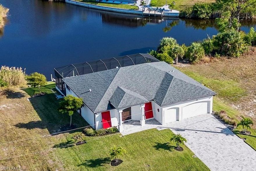 Enjoy the best of Southwest Florida living and entertaining in this beautifully maintained 2020-built home, offering rare intersecting canal views and a relaxed coastal lifestyle! The views can be enjoyed from the Great Room, the expansive 50’ wide lanai, outdoor shower, while fresh water fishing off your dock or while unwinding in the heated pool—ideal for everyday enjoyment, seasonal living, and gathering with friends and family.  Numerous desirable upgrades and extras are found throughout the home.  Designed with comfort and functionality in mind, the Great Room/Kitchen features the popular split-bedroom floor plan that balances open living with privacy. The shaker-style kitchen cabinets offer quality dovetail construction, anti-slam drawers, and upgraded trim, while the spacious center island provides both ample seating and entertaining space. Sought-after stacking sliders in the great room open fully to the outdoors, seamlessly connecting interior living to the 500 sq. ft. lanai and generous poolside areas—perfect for embracing the indoor-outdoor South Florida lifestyle.  The primary bedroom enjoys peaceful canal views from the slider with privacy screen, new carpeting (featured in all bedrooms), large walk-in closet, double vanities with  granite counters plus large glass shower. Two additional bedrooms are located on the opposite side of the home, along with a large office offering flexible use for guests or additional living space. The three-car garage adds exceptional versatility with a brand-new epoxy floor, utility sink, pull-down attic storage, and an overhead two-car screen door—ideal for enjoying the refreshing Gulf breezes.  This property is all set for any storm with impact windows and doors, accordion-style shutters for the lanai, and removable plantation-style metal shutters on the front of the home.  A generator hookup and a new portable generator are also included with the home. With the many upgrades throughout, please refer to the attachment for full details. Situated in the quiet Northwest corner of the Cape and near to the brand new Crystal Lake Park, enjoy shopping in both the Cape and also Punta Gorda with easy access to I-75.  This is a home designed for relaxed coastal living, effortless entertaining, and making lasting memories here in Southwest Florida.