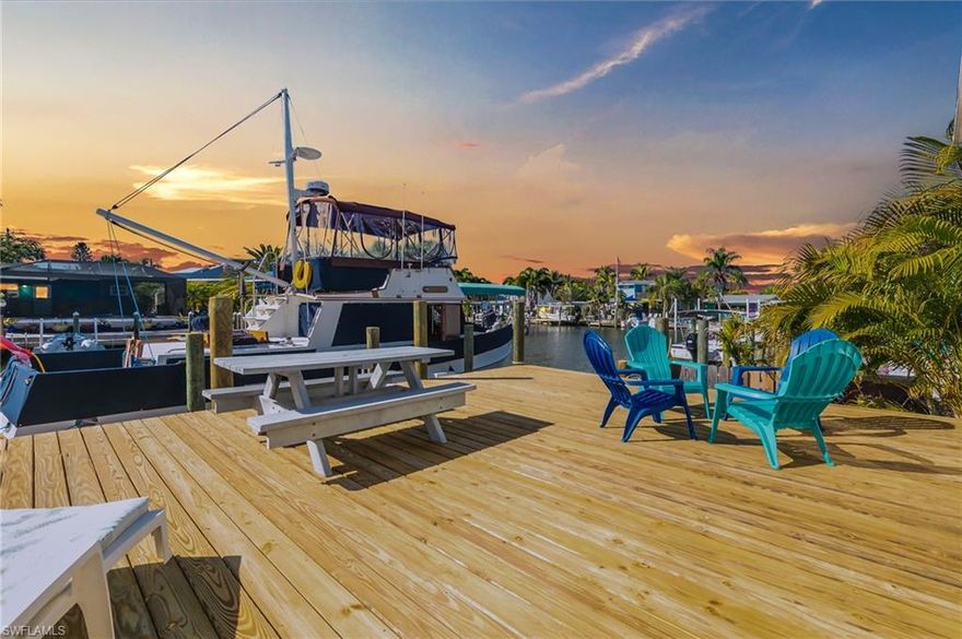 BOATERS PARADISE......this 2 bedroom 1 bath home is only a 4 minute boat ride to San Carlos Bay. The home is located on deep water sailboat access Henley canal.  New oversized dock is approx 1000 sq ft and is perfect for entertaining, SPECTACULAR sunset views or your morning coffee. Just a short boat ride to Sanibel, Captiva, Cayo Costa, Cabbage Key, and Useppa Island.  Cruise around on your golf cart to local eateries, bait shops, and the general store.  Local boat launch less than a mile away.