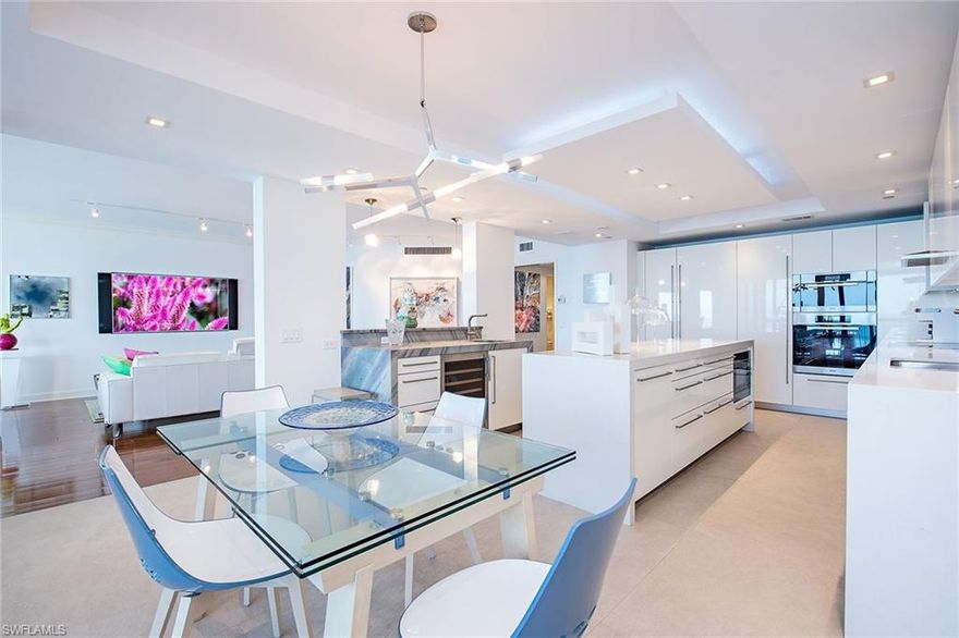 This chic and sophisticated 16th-floor beachfront residence has been masterfully reimagined, offering nearly 2,900 square feet of refined coastal luxury. Sweeping panoramic views of the Gulf, pristine beaches, and the Bay create a breathtaking backdrop from nearly every vantage point. The thoughtfully designed floor plan seamlessly connects the kitchen and living areas, ideal for elegant entertaining and relaxed everyday living. The gourmet kitchen showcases high-gloss custom cabinetry, an expansive island with substantial waterfall-edge quartz countertops and premium stainless steel appliances. The residence features three generous bedrooms, each with its own en-suite bath. Two of the baths are enhanced by custom handmade panels by renowned artist Alex Turco, adding a distinctive design element. The third bedroom, spacious enough to comfortably accommodate two double beds, is appointed with exquisite Italian sliding cut-glass doors that beautifully elevate the space. Additional highlights include 9-foot ceilings, dramatic floor-to-ceiling walls of glass, and three private lanais ideally positioned to capture spectacular sunrises and mesmerizing sunsets. Two deeded parking spaces are also included. The Biltmore has undergone complete renovation and features an elegant lobby, a sophisticated social room with catering kitchen, billiards, a well-appointed fitness center and an exceptional outdoor oasis featuring a heated pool and spa, fire pit and barbecue grills.