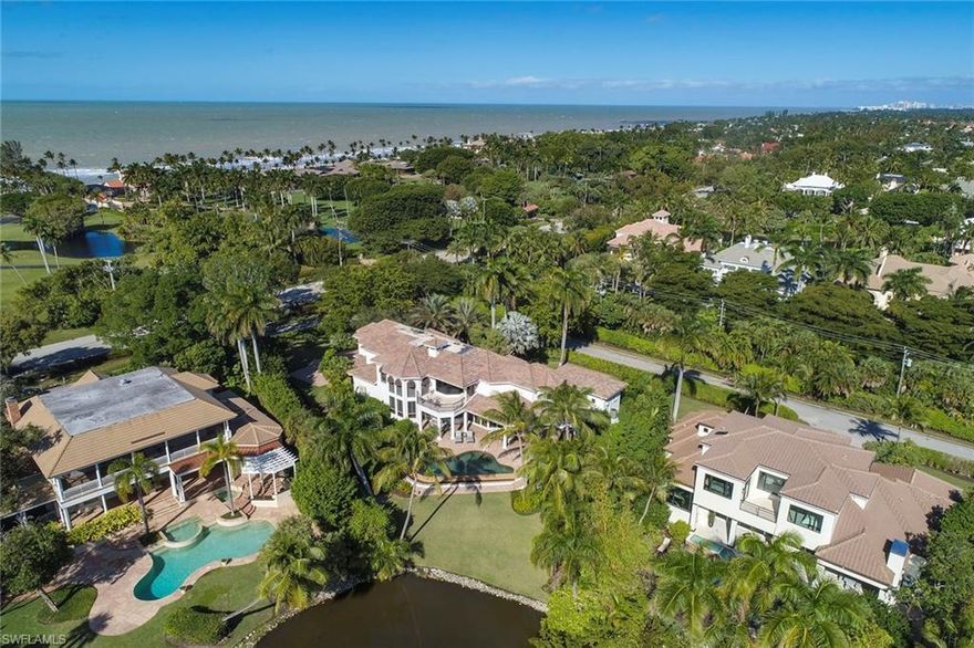 This one of a kind estate commands breathtaking, southern facing, panoramic water views of Lantern Lake in Port Royal. The elegant residence boasts a grand entry and expansive landscape featuring multiple gardens and car courtyard. The setting is tranquil and serene and offers extreme privacy. The presence of this home exudes quality craftsmanship throughout. From the moment you enter, the two-story great room captivates you. Featuring over 5,600 sq. ft. under air, 12’-24’ ceilings, 5 ensuite bedrooms, 6 full baths, and powder bath. The home also includes a lakeside library, 3 car garage, and a private elevator. Designed with two master suites, one on the first floor and a grand master suite on the second floor with balcony overlooking the lake. The chef’s kitchen is equipped with high end appliances and is adjacent to the breakfast room and large family room with sliding doors to the outside terrace. The large outdoor terrace with summer kitchen sits next to the infinity edge pool and spa providing plenty of room for entertainment. Port Royal Club membership eligible.