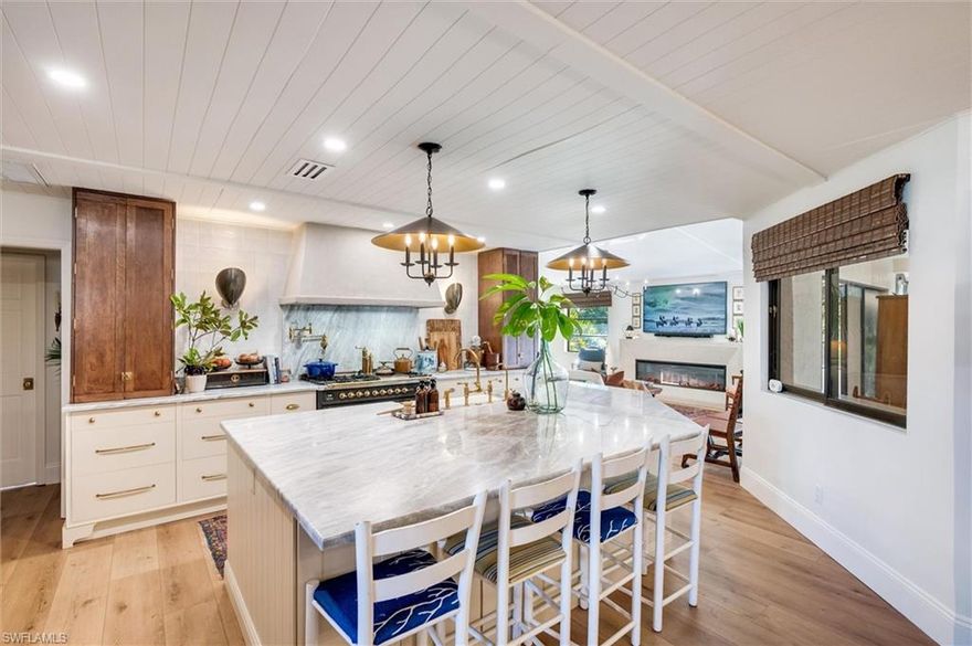 Welcome to this truly one-of-a-kind residence in Eagle Ridge. This thoughtfully renovated 3-bedroom plus den, 3-bath home showcases curated finishes and exceptional craftsmanship throughout. The stunning kitchen is the centerpiece, featuring dolomite countertops, a large island, and a porcelain farmhouse sink with a walnut drip edge. Design-forward details include an unlacquered brass faucet, brass cabinet pulls, and a paneled dishwasher, along with a reverse osmosis water system at the sink. Large, wired kitchen towers function as appliance garages while also providing additional storage, keeping countertops free and clear of everyday appliances. Built for serious cooking and entertaining, the kitchen offers dual fridge/freezers, a large dual-fuel range (electric oven and gas cooktop), double oven, pot filler, and a substantial hood vent. Two 40-gallon propane tanks service the gas cooktop. The living area features a built-in electric fireplace, creating a warm and inviting atmosphere. The primary suite serves as a private retreat and includes a secluded outdoor space just off the bathroom—ideal for a tranquil green space. Luxury vinyl plank flooring runs seamlessly across the entire home, complemented by tongue-and-groove ceilings that add warmth and personality to every room. Handcrafted bamboo Roman shades are installed throughout the house and will stay with the property.
Two additional guest bedrooms provide flexible living options, with one currently set up as a nursery. A well-appointed guest bathroom serves these rooms, while the den offers the perfect space for a home office, media room, or additional flex space. Outdoor living is just as impressive, with a pool, outdoor shower with hot water, and plenty of room for entertaining. A stylish pool bath with tasteful wallpaper adds plenty of personality. The property backs up to a nature preserve, enhancing privacy and tranquility and offering a peaceful setting for birdwatching.
Located in the established Eagle Ridge community, residents enjoy access to a public golf course with optional membership. HOA fees are only $673 per year and include high-speed fiber-optic internet. This is a truly unique home with a level of detail and finish that’s hard to find in Fort Myers.