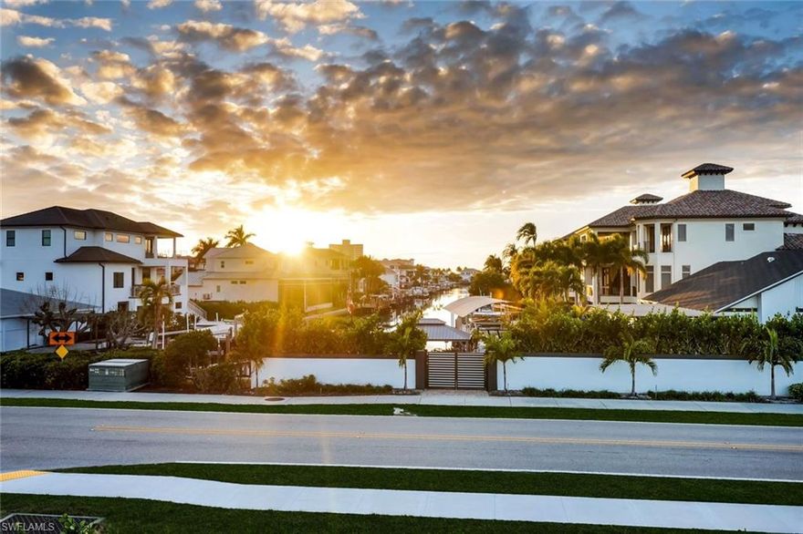 Striking architecture meets effortless coastal living in this fully reimagined 4/4 residence, ideally positioned along beautiful Vanderbilt Drive. Completely renovated and has a boat dock available! Sleek, contemporary aesthetic, this home features an open, light filled floor plan wrapped in a refined palette of soft greys and crisp whites. Offering approximately 2,265 sq ft with expansive screened lanai plus open air balcony. The living room has 9 ft ceilings with dramatic linear treatment which is anchored by expansive sliders fitted with remote controlled interior shades, delivering convenience and a clean, streamlined look. The kitchen makes a strong contemporary statement with a large island, sleek gray cabinetry and seamless finishes that elevate the space with premium appliances and 
Sub Zero refrigerator. Porcelain tile flows throughout boasting 4 en-suite bedrooms and baths plus tankless hot water heater, seamless metal roof, contemporary style front door accented by gray paver entrance. 
Thoughtful efficiency upgrades include a solar powered attic ventilator system enhancing comfort and energy performance. Outstanding second floor open air balcony offers elevated outdoor living with amazing long canal views and glowing sunset skies, accessed by a sculptural spiral staircase that adds visual interest. The breezeway and courtyard connection to the 2 car garage further enhances the Architectural flair.
Set in a stellar location just minutes from the beach, and plethora of fine and casual dining including shopping, this thoughtfully designed and confidently modern residence. Ideal as a primary residence, seasonal retreat, or investment opportunity, it delivers a rare combination of design, location, and lifestyle appeal. Come enjoy this ultimate water view from this sought after oversized corner lot with extraordinary long canal view.
Sits high and dry and never flooded.
Steps to white sugar sand beach, the Ritz, Mercato, and LA Fitness. Bike to the beach!