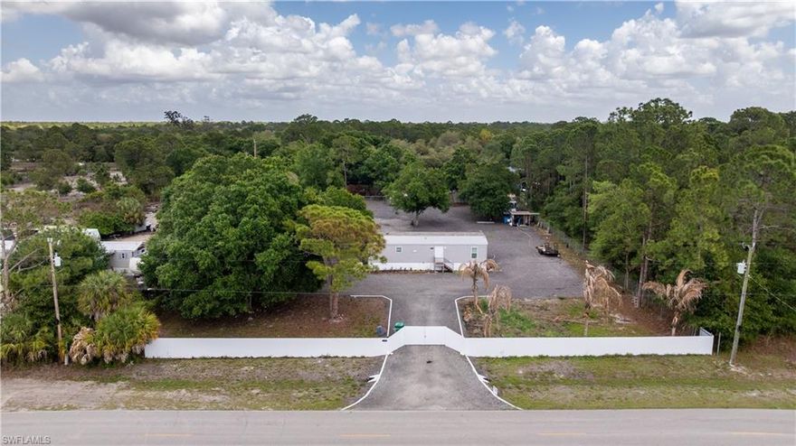 Shaded by mature oaks and set on over a fully fenced acre in the heart of Montura Ranch Estates, this like-new 2-bedroom, 1.5-bath home delivers the rural lifestyle you are searching for, at a price that makes sense. Built in 2022 and only recently occupied, it lives clean, fresh, and completely move-in ready.

The large covered deck creates a private outdoor retreat made for weekend cookouts, quiet mornings with a book, or evening gatherings with wine and friends. The entire property is fenced, with a metal privacy fence across the front of the lot, so you're ready for horses, goats, chickens, or whatever you're raising. The lot is cleared and ready for your toys, animals, or hosting fun family gatherings. Several mature oak trees offer the perfect shade to hang a hammock and soak in that peaceful countryside breeze.

Located on a primary street just down the road from the community mailbox kiosk and the clubhouse. You'll have quick access to amenities including a pool, basketball court, baseball and soccer fields, picnic areas, a playground, and an outdoor fitness space.

Clewiston is just 20 minutes away for dining, shopping, and Lake Okeechobee, known as the Bass Capital of the World. If adventure is more your speed, Skydive Spaceland is 10 minutes away, where you can take a skydive from 14,000 feet with jaw-dropping lake views. Prefer the beach? You're only about an hour from both coasts, with white-sand beaches, entertainment, and dining in either direction. Centrally located between I-75, I-95, RSW, and MIA makes traveling easy.

No HOA. A like-new home. A fully fenced-in acre. And one of the most unique rural communities in all of South Florida. Schedule your private showing today!