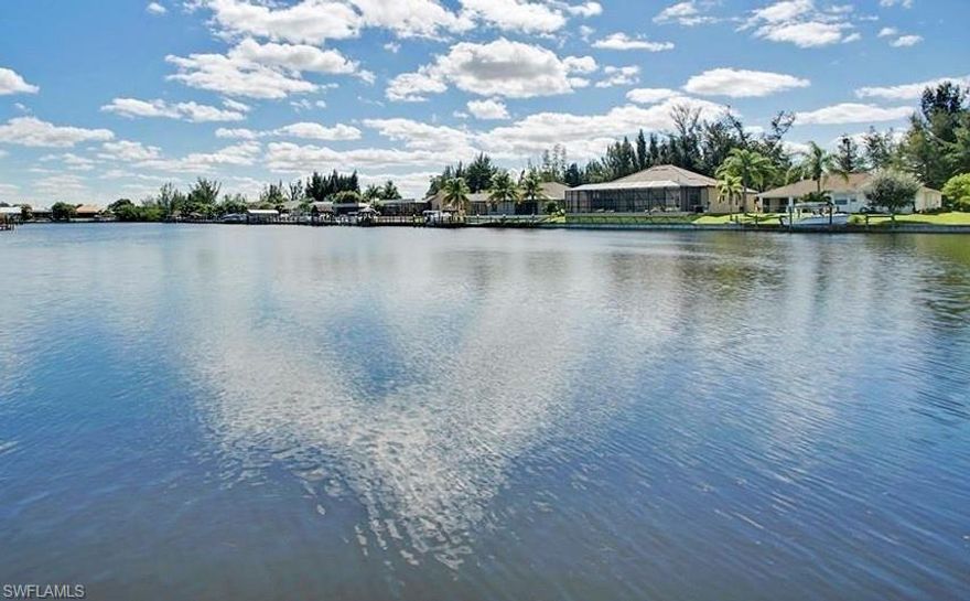 This lot is a WIN-WIN-WIN!  RARE PANORAMIC views from this OVERSIZED Direct Gulf Access lot allowing you to be in deep water in 10 mins on your way to the Gulf of Mexico or nearby islands. Take a moment and walk to the waterfront to see the over 3-FOOTBALL FIELDS LONG view down Lake Massey well known for being a manatee hangout. 108 FT wide waterfront with SEAWALL (nearly 30 ft wider than standard) allows you to IMMEDIATELY start building the HUGE home of your dreams. Nearby is the future Gulf Gateway Resort and Marina (Seven Islands) just turned over to the Developer this year to build a high end yachting community. This community will be breaking ground soon. This lot is oversized giving you more space for that large home and its 3 or 4-car garage and more waterfront view to enjoy and dock space. You're also just a short walk to Joe Stonis Park, Sirenia Vista Park, and the future Tropicana Park. These 3 parks provide FREE amenities of Pickleball, Tennis, Exercise equip, walking paths and much more. Nearby are Publix, Walgreens, Restaurants and more are planned. Also nearby are several waterfront restaurants including Micelis, a popular restaurant and watering hole. There's also several restaurants and world class fishing nearby. Or boat to many beautiful nearby islands including famous Sanibel, Captiva, Boca Grande, and many more not as well known on your way to the Gulf of Mexico. City waiting on permit to dredge channel along Pine Island RD all the way to Matlacha channel for deeper draft boats with the goal of up to 75' long boats accessing this area!  DUH! Balance of unpaid utility assessments is $9,473.10 per City's website as of March 2026. Plus there's NO HOA fees! WOW!!!