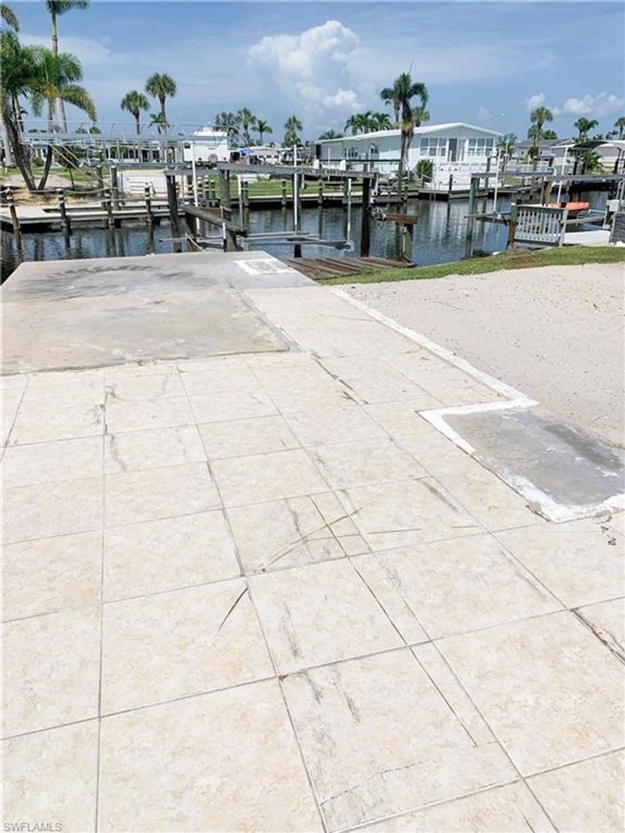 Enjoy great canal views and gulf access in minutes from this lot in Bayside Estates! This property is ready for a new owner to create their dream home in paradise. Boat lift is in good condition, but will need new motors. Bayside Estates is a 55+, manufactured home community. Lot size is approximately 50x91’. Buyers in Bayside pay a $2400 resale capital contribution fee. Bayside Estates is a highly desirable community, close to beaches, restaurants and more!
