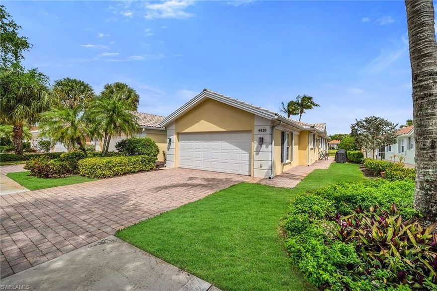 Set against tranquil lake views, this beautifully maintained residence in Island Walk offers a peaceful retreat with a thoughtfully designed 2-bedroom, 2-bath floor plan and a spacious 2-car garage. The screened lanai creates an inviting covered outdoor living space complete with a ceiling fan and sweeping water views, perfect for relaxing mornings or evening gatherings. Storm shutters provide added peace of mind, blending comfort with practicality. Inside, the home features tile flooring throughout the main living areas and soaring vaulted ceilings that enhance the open, airy feel. The kitchen is well-appointed with recessed lighting, white cabinetry, a convenient breakfast bar, and a full suite of stainless steel appliances including a microwave, range, dishwasher, and refrigerator/freezer. The living room is designed for effortless indoor-outdoor living, featuring a ceiling fan and glass sliders that open directly to the lanai. A separate family room offers additional space to unwind, highlighted by a ceiling fan, built-ins surrounding the TV, and custom mirrors that add depth and style. The primary suite is a private haven with serene lake views, vinyl flooring, and generous walk-in closets. The ensuite bathroom includes dual vanities with a full mirror and a walk-in shower with glass enclosure. The guest bedroom features vinyl flooring and a closet, while the nearby hallway bath includes a convenient shower and tub combination. A dedicated laundry area is equipped with a GE washer and dryer along with a laundry tub for added functionality. Residents enjoy access to the exceptional amenities of Island Walk, including a vibrant Town Center with a clubhouse, U.S. Post Office, restaurant, hair salon, nail salon, fitness center, resort-style pool, lap pool, tennis courts, bocce, pickleball, putting green, gas station, car wash, scenic walking paths, and so much more—offering a lifestyle of convenience, recreation, and community in one of Naples’ most desirable settings.