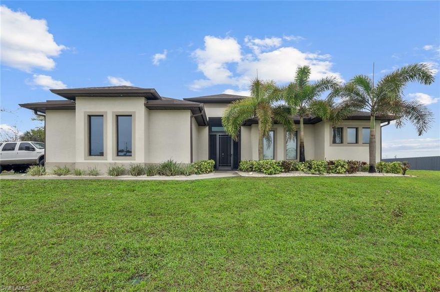 Welcome to this beautifully designed residence situated on a 2.73-acre 100% uplands lot, offering the perfect combination of modern living, privacy, and full usability...no wetlands, no wasted space.  This home showcases an open-concept layout filled with natural light, enhanced by high ceilings, elegant tray details, and expansive sliding glass doors that seamlessly connect indoor and outdoor living. The spacious living area flows effortlessly into a stunning chef’s kitchen,  sleek cabinetry, stainless steel appliances, and ample counter space perfect for entertaining or everyday living. The primary suite is a private retreat, complete with generous space, a luxurious bathroom with dual vanities, a walk-in shower, and refined finishes throughout. Additional bedrooms are well-sized and versatile, ideal for family, guests, or a home office. Step outside to enjoy a large covered lanai, ideal for relaxing or hosting gatherings while overlooking your expansive property. This lot offers endless possibilities add a guest house, pool, workshop, RV storage, or simply enjoy unmatched privacy and space. This property provides the freedom of acreage living while still being conveniently close to shopping, dining, and top-rated schools.