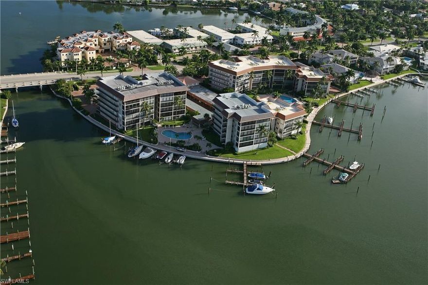 Gorgeous wide, southerly views of Moorings Bay!  Spacious 2BD/2BA includes a BOAT SLIP with purchase.  Unit is in great condition with remodeled kitchen and baths.  Sold turn-key furnished!  Glass sliders on screened lanai.  Only two units per floor.  Large, private, storage room (10'x7') outside back door of condo.  New roof and carport roof!  New A/C in early 2026!  Enjoy a community pool with a chickee area for socials w/bar-b-q grills.  Assigned carport.  Just a short walk to the beach.  Sailers....no bridges to the Gulf which is approx. a 1/4 mile away.