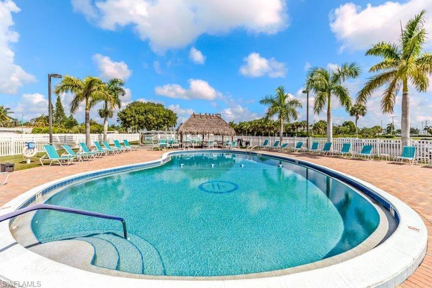 Discover easy, affordable living in this charming home located within a vibrant 55+ community in desirable South Naples. As a shareholder in the co-op, you’ll enjoy an exceptionally low monthly maintenance fee of just $86—covering lawn care, water, sewer, garbage, and access to community amenities. This well-maintained residence features 2 bedrooms, 1 full bath, 1 half bath, plus a versatile bonus room perfect for a home office, den, or additional sleeping space. The spacious, updated kitchen boasts newer cabinetry, countertops, and a full suite of appliances—including a washer and dryer. Stylish laminate flooring runs throughout the main living areas, complemented by tile flooring in the primary bathroom. Recent upgrades to the kitchen and both bathrooms, along with fresh interior paint, give the home a clean, updated feel throughout.  Storage is plentiful with a covered 1-car carport and a large attached storage area located behind the screened lanai—ideal for tools, beach gear, or seasonal items. Best of all, the home is being sold turnkey, making your move seamless and stress-free. Residents of the Hitching Post community enjoy a variety of amenities, including a pool, shuffleboard courts, horseshoe pits, and a community clubhouse. Conveniently located near shopping, dining, beautiful Gulf beaches, and Marco Island, this home offers the perfect blend of comfort, convenience, and value. Don’t miss this opportunity to own a slice of paradise in Southwest Florida!