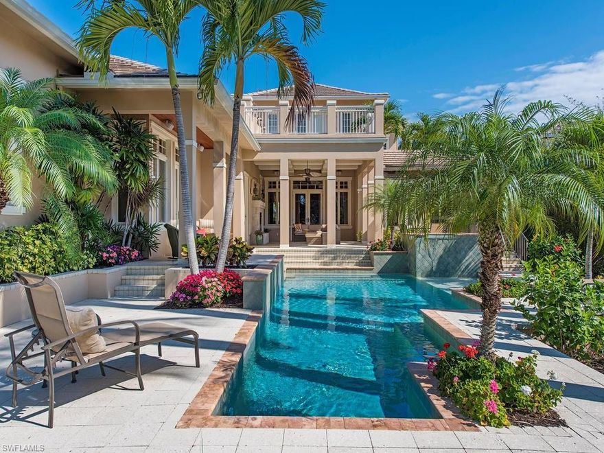 H.12207  
Island-Style Elegance.  This remarkable lakefront home with timeless British West Indies architecture and casual Caribbean flair is the perfect private retreat one block from the beach and a short walk to Third Street restaurants and shops. Designed by Stoff-Cooney Architects and superbly crafted, the first floor of the 5 bedrooms plus den home includes a formal foyer, living and dining room with rustic Jerusalem stone flooring and beamed ceilings, spacious family and club rooms, a spectacular kitchen, one guest suite and a romantic master bedroom and bath.  The inviting, south-facing outdoor living area with fireplace and summer kitchen overlooks a tropical heated pool and spa with waterfall, lush landscaping and tranquil lake with peaceful and private views.  The second floor features three guest suites and baths and a rooftop terrace.  In harmony with the natural beauty surrounding it and positioned just 4 homes from the Gulf and within easy walking distance to the amenities that make the downtown lifestyle so enjoyable, this distinctive luxury residence captures the essence of living in Naples!