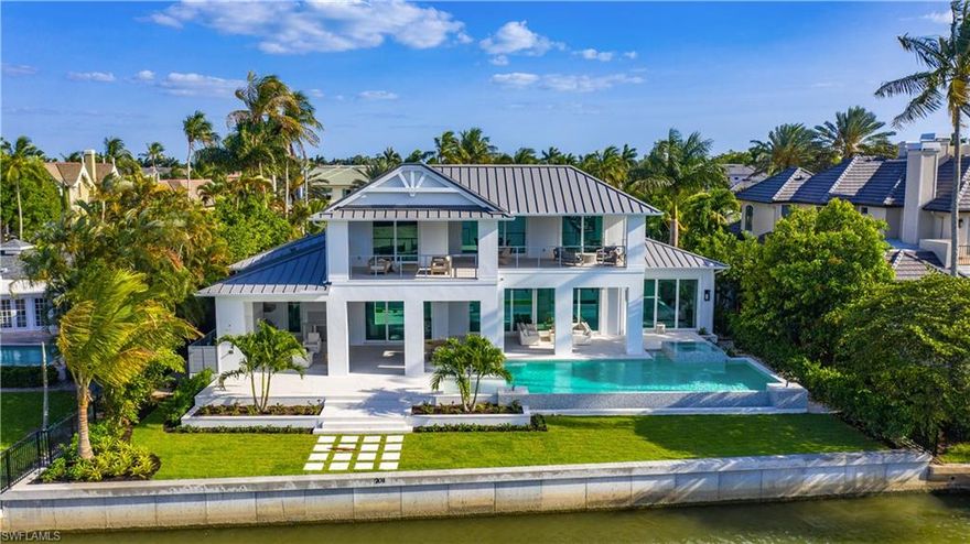 Coastal living at its best - the perfect retreat for those seeking a most sophisticated waterfront lifestyle! A new construction opportunity in the sought-after community of Aqualane Shores, this luxury waterfront home is perfectly positioned on intersecting canals with long water vistas down Gull Cove. Enjoy transitional and timeless architecture with designer interiors featuring exceptional quality artistry and materials. The home has five bedrooms, a study, main-floor master and guest suites, chef’s kitchen with large island, butler’s pantry, climate-controlled wine cellar, fully-stocked wet bar, private elevator, upper-level VIP suite, large living area with wet bar, three-car garage and magnificent outdoor living areas. A boater’s paradise with a new seawall and easy access to Naples Bay and the Gulf of Mexico with no bridges. Superb location - a stone’s throw from the beach and the celebrated upscale shops and restaurants of Downtown Naples’ Third Street South. Estimated completion in early 2021.