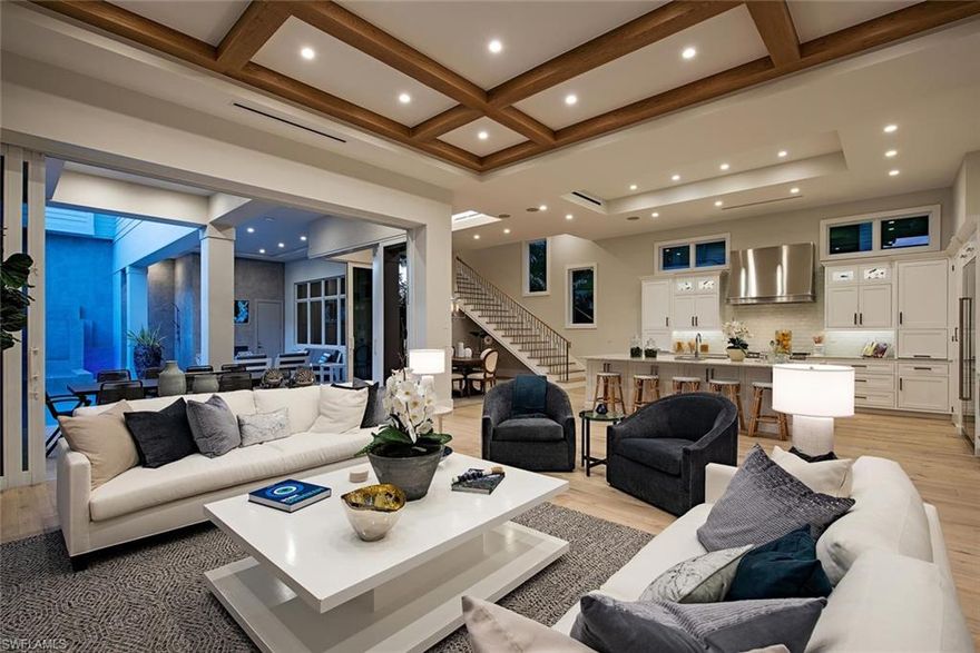 Recently completed in an ideal Old Naples location; 7 blocks to the beach, 2 blocks to Cambier Park and 5 blocks to 5th Ave. S. Beautiful beamed, volume ceilings, wide white oak flooring, grand entry with an abundance of natural light, oversized kitchen island with tremendous extra storage, Sub-Zero / Wolf / Asko appliances, quality Anderson windows, Control 4 home automation system, large "hidden" pantry, and pocketing Great Room glass sliders for maximum indoor / outdoor living and light. The master suite & master bath are exquisite, spacious guest bedroom suites, casual gathering area with thoughtful under counter fridge with ice maker, microwave, and wet sink. The outdoor living area is accentuated by pool/spa, stainless steel summer kitchen, gas bead fire bed, flat panel TV, and outdoor shower. There is a 3-car garage, elevator and generator. A perfect residence to immerse yourself into the casual but elegant Naples lifestyle.