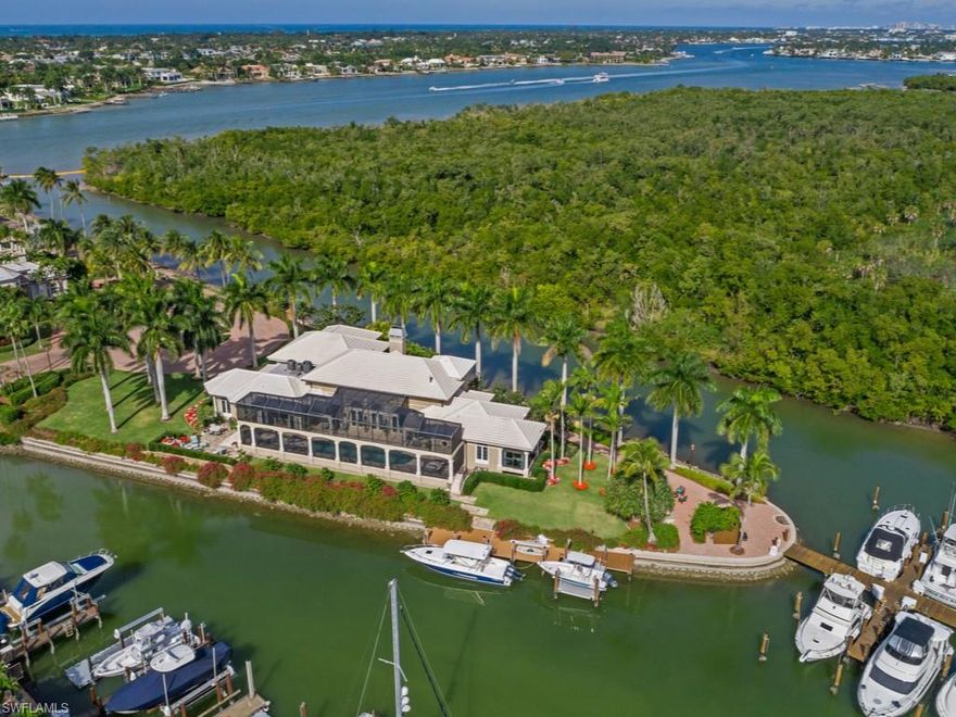 One of a kind estate home, on a private, gated street of 10 homes on Naples Bay, surrounded by water on three sides. No expense spared in the total renovation of this home over the past eight years. From top to bottom and inside and out. 75' of private dock, with lift, for your boat outside your door. Over an acre of property, all on the water with water views from every room. Plenty of cozy retreats with a study off the master bedroom and a crows nest office on the second floor. Separate second floor guest suite with two bedrooms, two baths and a sitting room with kitchenette.
All of this in the gated community of Windstar. Windstar is a unique community with a deep water harbor and a golf course very close to Old Naples. Memberships are available to the club, but not required. Club amenities include a Tom Fazio designed golf course, a dining room overlooking Naples Bay, tennis and fitness programs, as well as other social activities. Windstar also offers a shuttle boat to Keywaydin Island which boasts seven miles of unspoiled beach. Truly a one of a kind property in paradise.