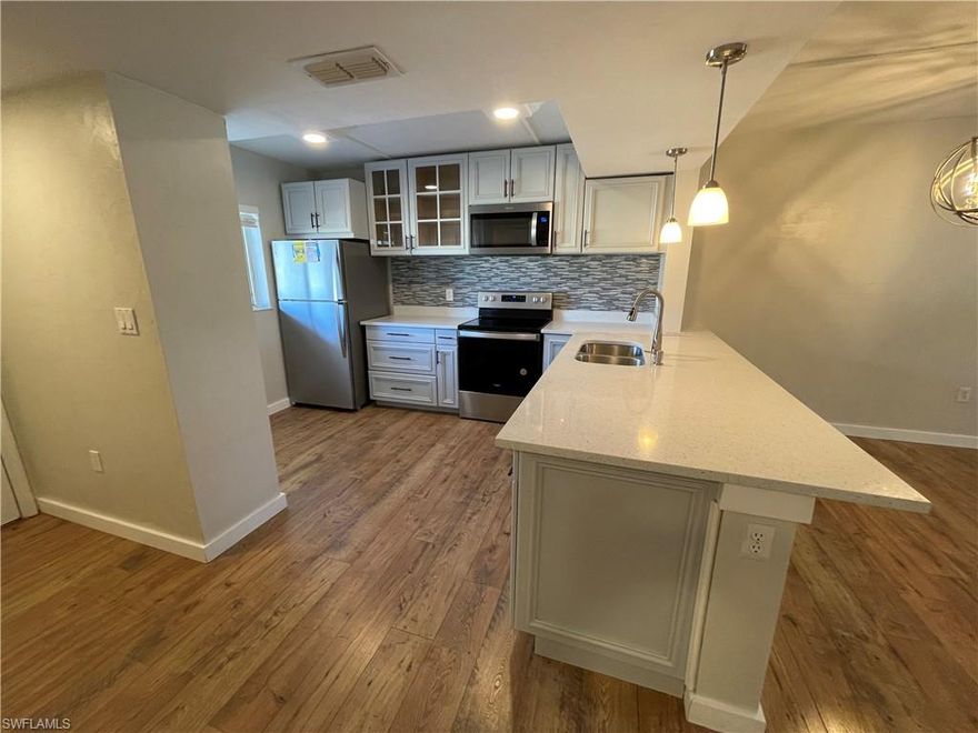 Welcome to the ANNUAL RENTAL - 2ND FLOOR 2/2 AT NAPLES TRACE, a stunning condo located in the heart of Naples, FL. This fully remodeled unit boasts two spacious bedrooms and two full bathrooms, offering ample space for comfort and relaxation. The condo features a modern kitchen equipped with stainless steel appliances, quartz countertops, and sleek white cabinets, perfect for those who love to cook. The updated flooring throughout the unit adds a touch of elegance and sophistication. The condo also includes a laundry unit for your convenience. Step outside to the screened and covered lanai, a perfect spot to enjoy the Florida weather. As a resident, you'll have access to the community pool, a great place to cool off during the hot summer days. This prime location condo is a perfect blend of style, comfort, and convenience. Don't miss out on this exceptional living experience in Naples Trace.