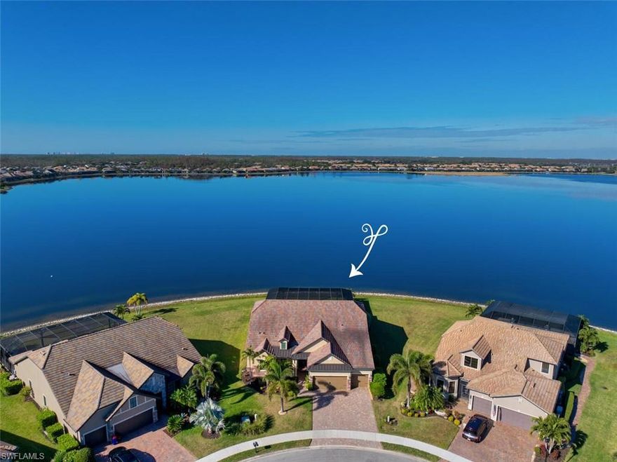 Corkscrew Shores is a gated lakefront sanctuary offering breathtaking natural panoramas and a wealth of community amenities perfect for an active and social lifestyle. Picture yourself enjoying the clubhouse, fitness center, tennis courts, pickleball, bocce ball, and non-motorized watercraft and then coming home. This luxurious 4-bedroom, 3-bath home with a dedicated office and a versatile den or wine room rests on a premium peninsula lot. The home features an air-conditioned 3-car garage, top-of-the-line appliances, a wine cooler, elegant cabinetry, modern tile, a high-end outdoor kitchen, an expansive lanai, Storm Smart shutters to protect the outdoor kitchen and dining area, and impact-resistant doors and windows. The disappearing slider doors in the living and dining areas seamlessly blend indoor and outdoor living, inviting you to embrace the Florida experience fully. The waterfront view is even more expansive than Naples Bay, with no neighboring houses in sight from the lanai. The spacious lanai also boasts an oversized pool with dual heating options, including a 500-gallon propane tank, heat pump, and spa. Furnishings are available, ensuring your move-in is seamless and stress-free. This unparalleled home invites you to make every day feel like a vacation.
