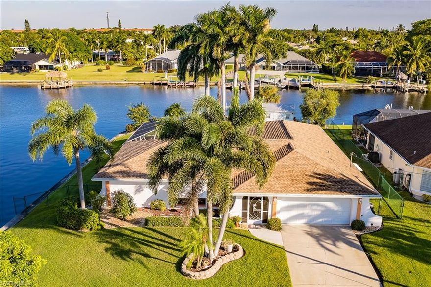 WOW! WHAT A VIEW! Gulf Access on Intersecting Canals with approximately 240 Ft of Shoreline! 15 Minutes to the river by boat and backing to the 200 Ft Wide Rubican Canal this Oversize 1/3 Acre Lot is one the finest private waterfront lots Cape Coral has to offer!  Over 2100 Sq ft plus an oversize 2 car garage this home features a Beautiful updated Kitchen with Stainless Steel Appliances, pass through window to Lanai, wet bar in Family Room, Pocket Sliders in the Family Room, Dining Room and Master Bedroom, large Laundry Room, and so much more! Roof is brand new in 2021, 2 zone A/C (one unit is 5 years other is 10). Concrete and wood dock with lift and plenty of shoreline to add additional docks if desired! Large Storage shed and Mature Palms seal the deal on this amazing opportunity to own this home! Did I mention the View from the Pool and Lanai and nearly every Room in the house? Yes I did, but once was not enough come see it for yourself!