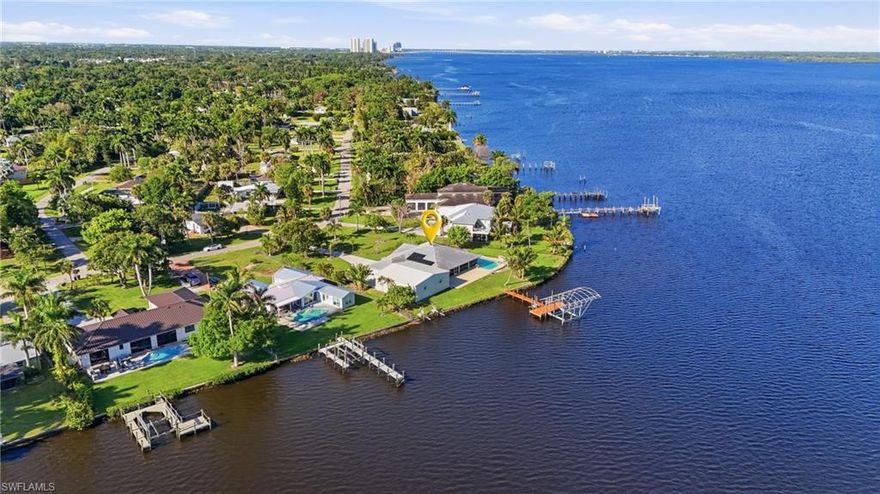 Welcome to one of the largest riverfront estates currently offered on the Caloosahatchee River in Fort Myers. Situated on two expansive lots totaling nearly three-quarters of an acre, this rare property delivers an exceptional blend of space, privacy, and true Southwest Florida waterfront living.

Enjoy Direct Gulf Sail-Boat Access with no bridges, making this a boater’s dream. The property features a private Boat Dock and Lift, offering quick and effortless access to open water. Whether you're heading out for a sunset cruise or a day of fishing, this location is perfectly suited for an active waterfront lifestyle.

The estate provides abundant outdoor space with endless possibilities—ideal for entertaining, expanding, or simply enjoying the serene riverfront setting. A standout feature is the detached 1,600-square-foot garage with a two post car lift, perfect for storing multiple vehicles, boats, RVs, or creating a workshop or hobby space. There is ample room throughout the property to accommodate all your recreational needs.

Opportunities like this are rare—own a premier riverfront property with unmatched size, flexibility, and boating access in one of Fort Myers’ most desirable waterfront corridors.