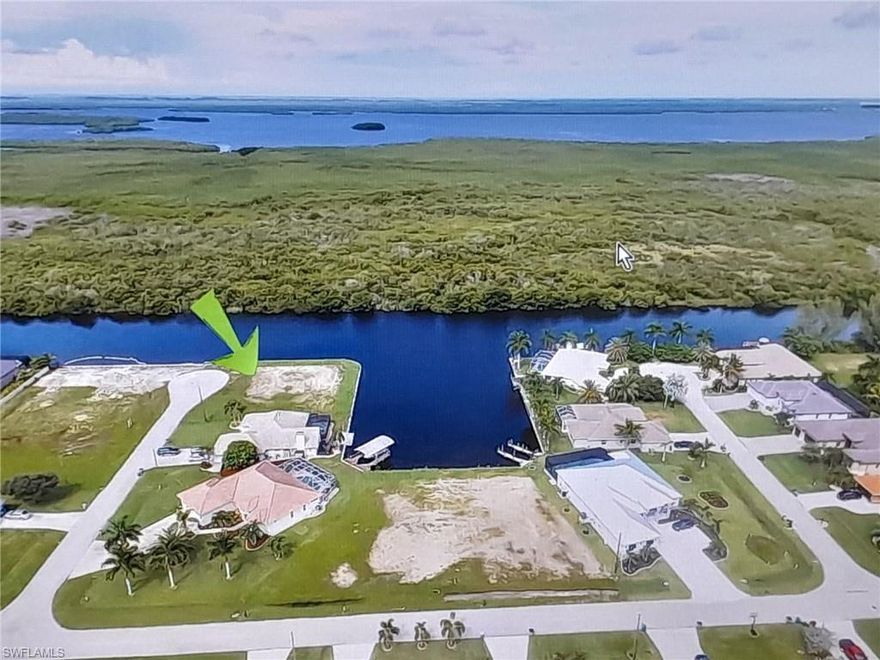 **Premier Oversized Corner Lot – Cape Coral Waterfront Gem**  
Build your dream home on this rare **0.418-acre** (approx. 139 x 125 ft) corner parcel—over triple the size of a standard Cape Coral lot! Prime double-sided frontage on the wide **200-ft spreader canal**, offering expansive water views along **two sides**.

Enjoy unobstructed western exposure across the serene canal to protected **mangroves**—guaranteeing privacy and stunning **daily sunsets** right from your future backyard. New **295-ft extra-high seawall** (1.5 ft above standard) provides superior protection and durability.

All assessments **paid in full**! Ideal for a spacious residence, pool, dock, and outdoor oasis in one of Cape Coral's most desirable waterfront areas.

Boater-friendly location with natural beauty and direct Gulf-access (no bridge!). Don't miss this exceptional, build-ready opportunity—your slice of Florida paradise awaits!