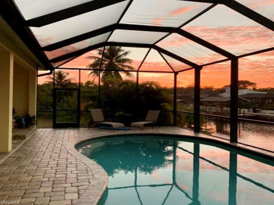 Located 8 minutes from Manatee Bay by boat, this amazing Key West style ranch home with volume ceilings awaits a new owner. With stunning wood-look tile throughout, this 4 bedroom, 2 bath home in Pine Island features granite counter tops in the kitchen and bar, and marble counter tops in the bathrooms. The large master bedroom, with its spacious walk-in closet, leads to a gorgeous master bathroom with a walk through shower and a separate slipper clawfoot tub. The beautiful screened in pool is equipped with both solar heat and an electric heat pump. With a new dock and seawall in 2018, and a 10,000 lb boat lift with Gem remote system, this home is a boater's dream.