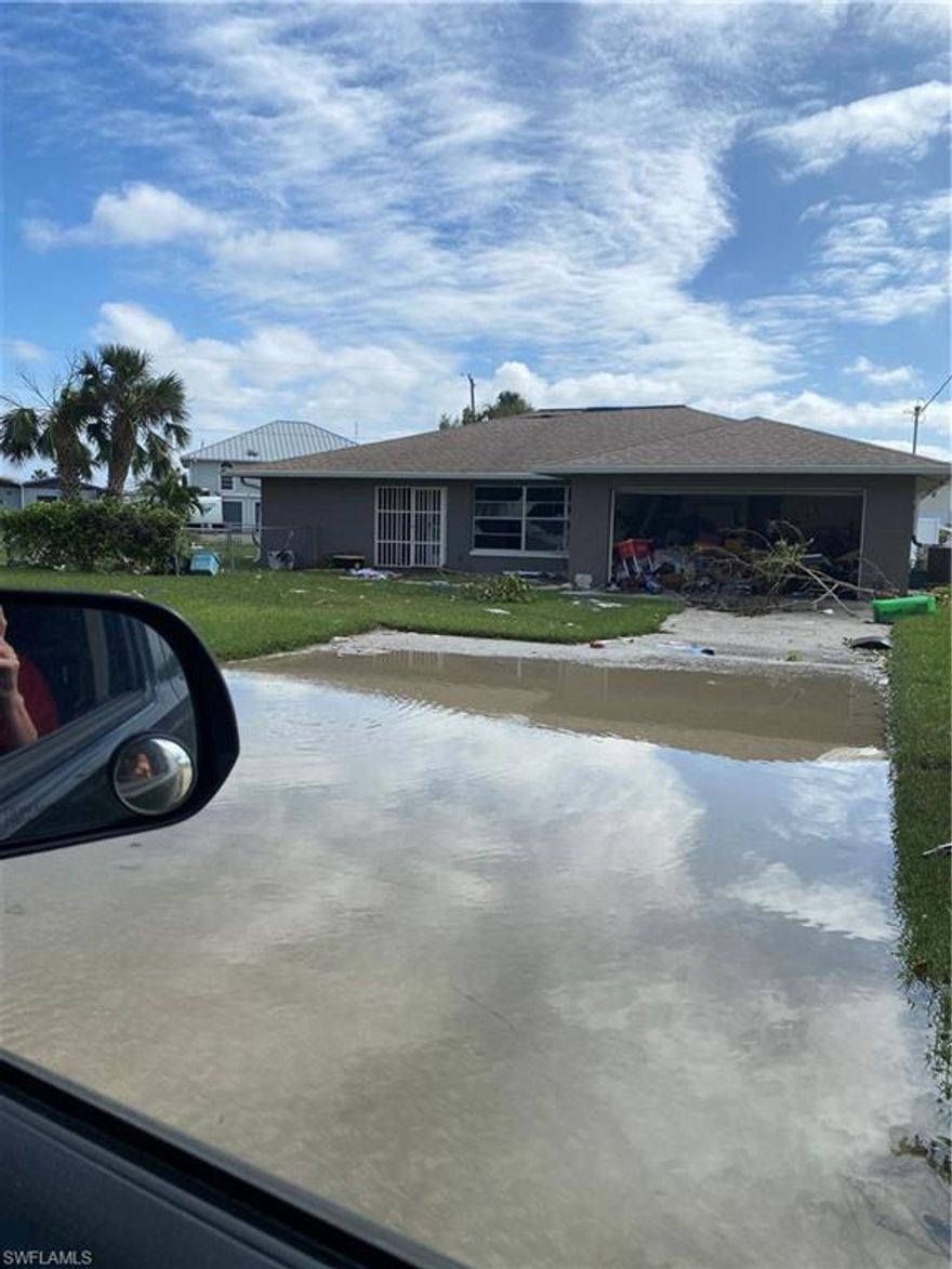 One of the largest corner lots in Tip Top Isles. This property features lots of yard space and 100ft of water frontage. Home sustained damage from hurricane Ian. Being sold as is, property is currently uninhabitable will need work. Please do not enter property as it is currently unsafe. Home can be sold as a shell or possibly knocked down. Great opportunity to make your own beach house!!!
