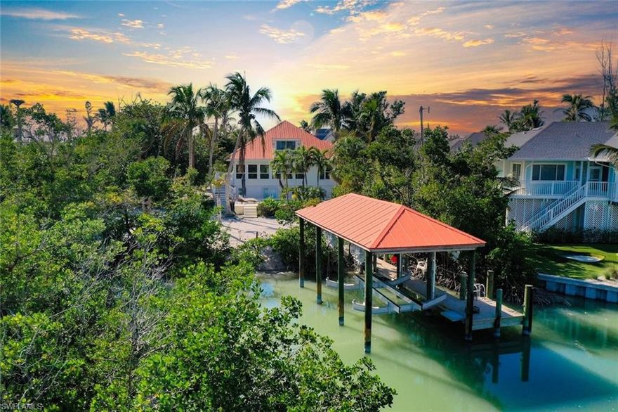 Welcome to your Captiva Island oasis! This Gorgeous home is the perfect island get-a-way- situated on Roosevelt channel offering direct Gulf access from your private dock and a rare boathouse with 20,000lb. boat lift- the natural shoreline adds privacy and allows for a great kayak/SUP launch area. Just a short stroll to one of the best beaches and shelling locations! This 3 bedroom, 3 bath, pool home has Travertine floors throughout main living level and hardwood floors in the private, 2nd floor primary suite. The primary suite has vaulted/beamed ceiling & a private sunning deck w/water views. Primary bathroom has double sinks and custom glass tile. The kitchen has been completely renovated and cleverly designed to maximize storage and flow in the main living area, adding a custom island and space for a 60" range and hood, custom built-ins added in all bedroom closets, this home is light, bright and everything you want in an island home. After a day on the water, take a swim in the sparkling concrete elevated pool surrounded by lush tropical vegetation offering a feeling of seclusion and privacy. Newer Septic system, 2 a/c's 2022, washer & dryer 2025. Enjoy Island living, boating, fishing, shelling, sunning and stunning sunsets on Captiva Island. Property sold furnished, main living area and bedroom images are virtually staged adding accessories and artwork. Furniture is in place. 60" Range and hood in kitchen is virtually staged, propane tank installed and piped ready for range to be installed.