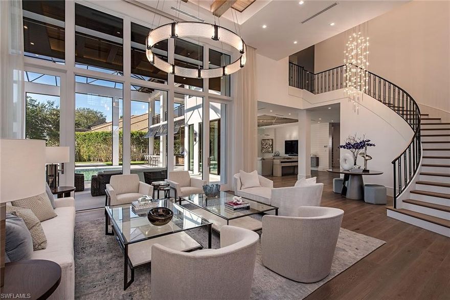 An “architectural masterpiece” in the heart of Bay Colony. The absolute finest specifications, long lake views, impeccable interior, incredible furnishings, and creative finishes in this estate home. Encompassing 6,925 square feet/9,399 square feet total. Two private garages offer four spaces. Soaring custom ceilings, light airy great room open to the family room, culinary kitchen and butler’s pantry. Expansive screened pool setting complete with delightful outdoor living area. Five full-bedroom suites. The master enjoys dual baths, separate walk-in closets, and custom built-ins along with a tranquil fireplace. A cabana suite on the master level, three additional suites on the upper level, open media room shared by all guests. Charming covered outdoor terrace overlooking the pool, lake view with private elevator to the spacious upper living. Residents enjoy a world-class setting, and seaside guard-gated community inclusive of a private beach club and tennis club along with all of Pelican Bay amenities. Initially constructed in 1999, this estate home has been rebuilt by BCB Homes featuring the “best of the best,” completed November 2022.