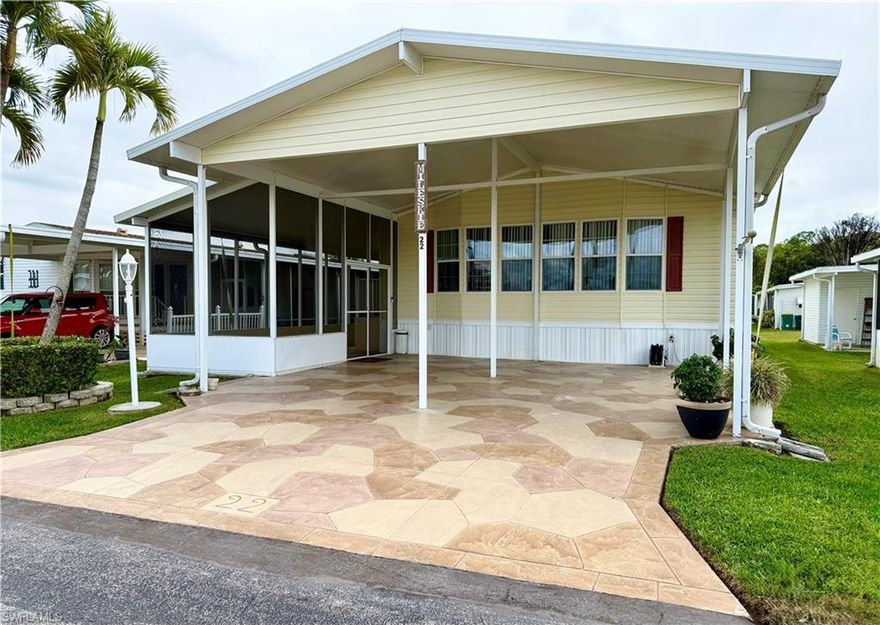 OUTSTANDING CONDITION! LARGE HOME! All you need to do is move into this truly charming 2Br/2Ba home with a large bonus room that could be the 3rd Bedroom! Thank you for viewing 22 Amethyst Avenue in Enchanting Shores, a Co-Op, in Naples, FL. This community of over 300 residential properties provides a very active social calendar, boat ramp, boat storage, and trailer storage. You’ll appreciate the spacious clubhouse, sparkling pool, bocce, horseshoes, pickleball, tennis, and shuffleboard areas. The HOA fee of $500. per quarter covers water, lawn care, sewage, trash/recycling, and the community amenities. Of immense importance, this home offers a kitchen that was fully renovated in 2022. The updates include dual convection ovens (1 is also a microwave), an induction cooktop, all stainless-steel appliances, granite countertops, large sink, and a large center island. Additionally, the owner’s en suite boasts a huge bathroom with granite countertop, shower with 2 seats, large soaking tub, and double sinks. The bedroom area is extremely spacious with a generous closet offering built-in shelves and clothing racks. In the laundry room you’ll appreciate the super-size washer and dryer, folding counter, cabinets, and storage shelves. The second bedroom is very roomy and also provides ample closet space. The bonus room is currently designed as an office area with a built-in desk, cabinets, and a window seat. The gathering area contains vaulted ceilings, a living room, and dining area. On top of all of these features, the walls provide supplemental thickness, drywall, curved corners, and extra-wide hallways. Outside of the living area, you will enjoy the screened lanai, massive storage room, and very expansive carport. Finally, some very recent updates include 3 split-unit air conditioners and a 50-gallon hot water tank. Truly, this home is a must-see for anyone seeking a spacious, well-maintained residence in tropical Naples, Florida!