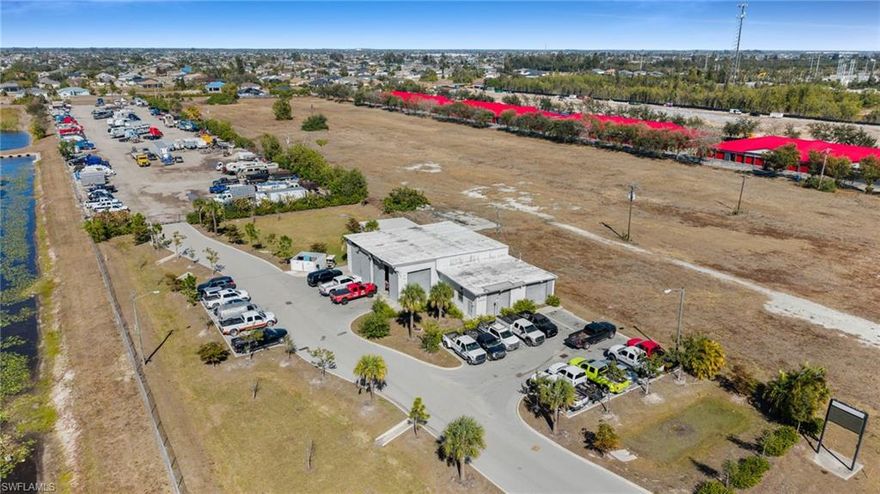 Why wait to develop when you can own an income-producing asset with exceptional future potential? Rare investment opportunity offering approximately 5.87 acres along highly traveled SW Pine Island Road in Cape Coral. Currently operating as a cash-flowing outdoor storage facility with approximately 185+ parking spaces, this unique property also includes a large repair shop featuring 2 oversized 18’ overhead bays, 4 additional bays, and office space. Utilized for boat and auto repair, the property offers excellent flexibility for a variety of commercial uses.
The site is fully fenced with keypad entry and security cameras, providing secure access for tenants and operations. Approved city plans allow for expansion of the storage area, including a detention pond and fire hydrant access. Total acreage includes an additional 1.02-acre parcel on the north end facing Ceitus Parkway, included in the approved site plan. Improvements include a 6,000 sq ft shop building.
Prime location near major retailers and national brands, including the -anchored Coral Shores Shopping Plaza with, and nearby. Outstanding visibility, strong traffic counts, and future growth potential make this a premier commercial investment opportunity.