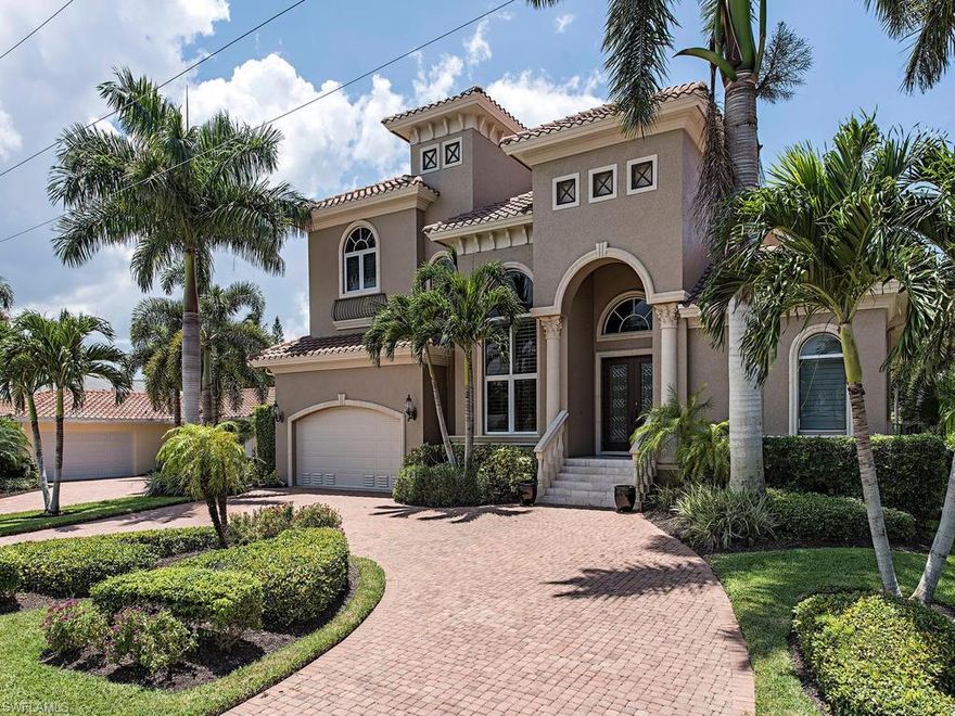 Welcome to home to this meticulously maintained, upgraded, waterfront home just blocks away from Vanderbilt beach!  This elegant, two-story, southern-exposure home provides over 5,000 square feet of total space, with four bedrooms and 3.5 baths.  On the first floor, entertain guests with the gourmet kitchen and luxurious dining room, relaxing afterwards in front of the outdoor fireplace on the private, expansive lanai.  Retreat to the master suite with spacious master bath and its French doors and plantation shutters leading to the lanai.  The second floor’s three bedrooms provide private quarters for guests and family, as well as a richly-appointed, wood-floored study.  Numerous features and upgrades include soaring ceilings, crown molding throughout, tile and wood flooring, decorator-appointed lighting fixtures and wall treatments, central vacuum, electric sun shades, two-zone A/C system, three-car garage, Control4 remote management system, and new Trex dock with covered, 10,000-pound boat lift.  This homes is conveniently located close to shopping and dining at Mercato, beaches and dining. Be sure to ask for the Feature Sheet for more details.