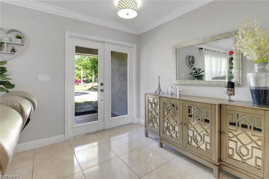 Get ready to be impressed by this beautifully revamped home, nestled on almost 3 acres of 100% upland. The layout is open and airy, with
ample-sized rooms, including both a living area and a cozy family room. Throughout the home, you'll find striking 20" x 20" porcelain titles,
brand-new wood cabinetry in the kitchen, and stunning natural quartzite countertops. The home features elegant crown molding, large 6"
baseboards, and sleek custom floating vanities in both bathrooms. Additional perks include a modern bioethanol fireplace, hurricane-grade
windows and doors, and much more! The expansive, tiled, screened-in lanai is built with strong aluminum columns and framework. Plus, there's
a roomy two-car garage and an indoor utility area. This is a must see, showcasing all the upgrades with pride! MOTIVATED SELLER!!
CONTRIBUTING TOWARDS BUYERS CLOSING COSTS!!!! ENTIRE HOME REVERSE OSMOSIS, ROOF 2019, AC 2023